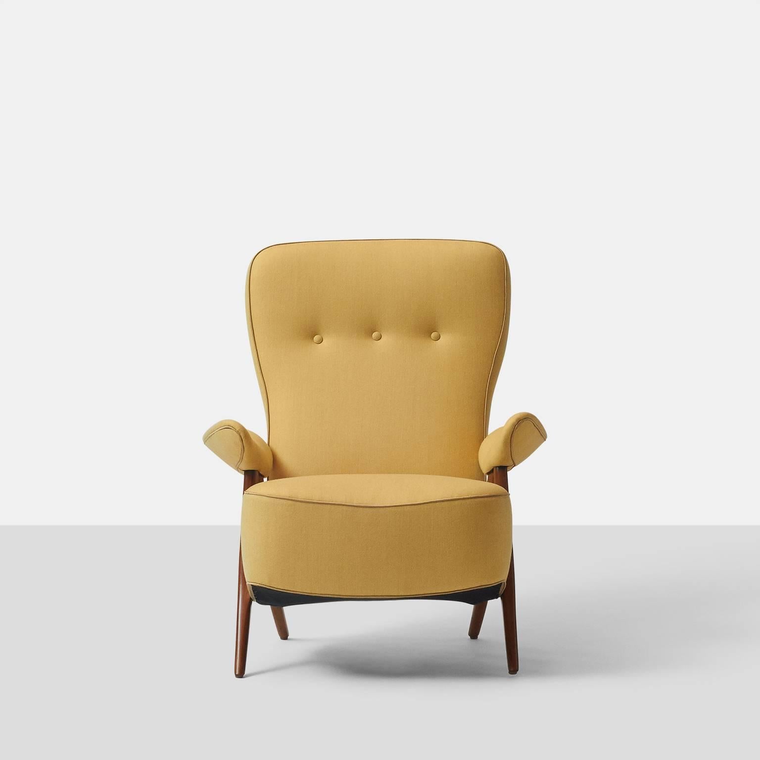 A lounge chair model #105 by Theo Ruth for Artifort made in 1950, also known as the hair pin chair. The chair has been completely restored in a wool suit fabric from Holland & Sherry with contrast silk trim. Retains the original brass Artifort label.