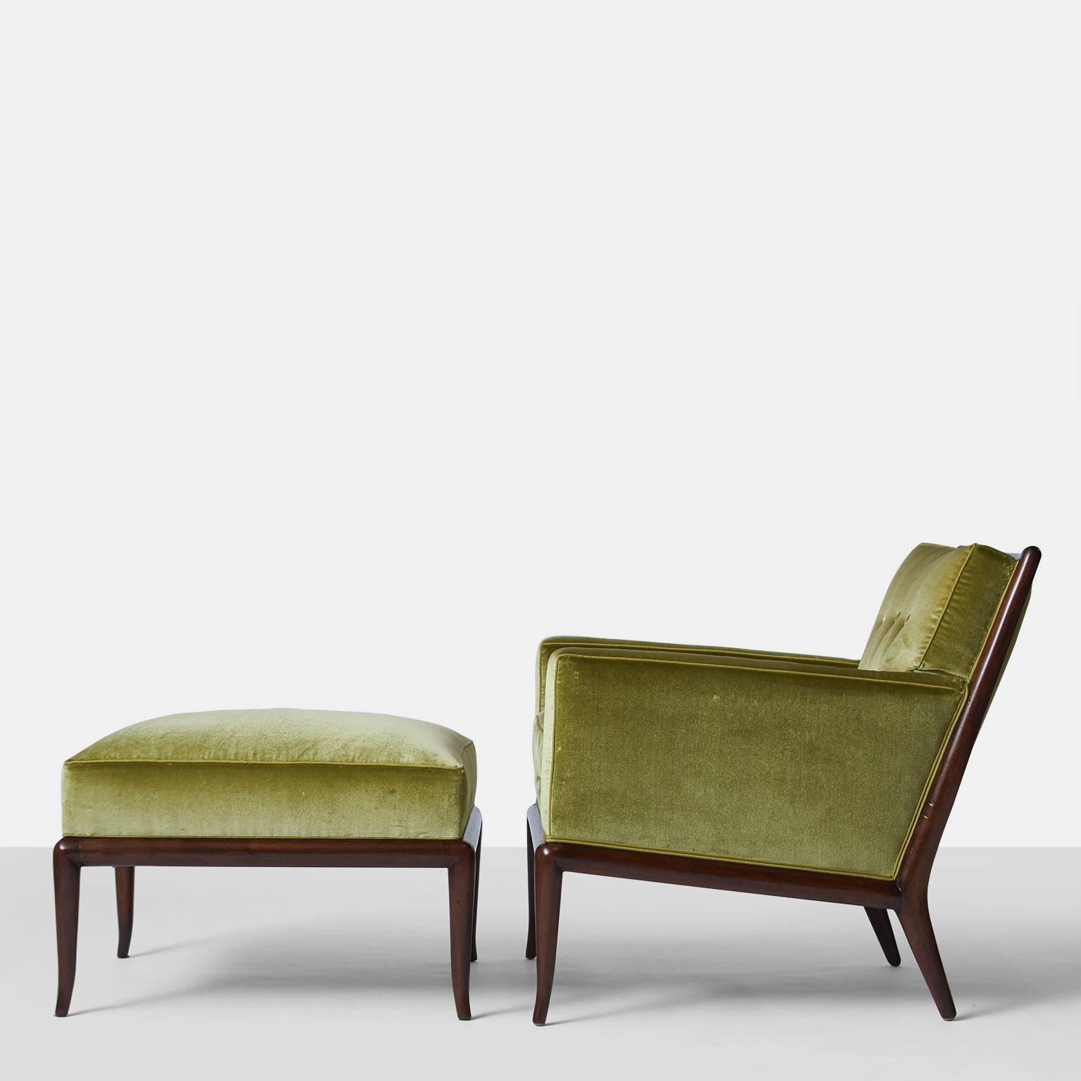 An upholstered lounge chair and ottoman with a walnut frame and covered in a luxurious deep apple green Holland & Sherry silk velvet with contrast silk trim. Tufted attached back cushion and a down filled seat cushion. TH Robsjohn-Gibbings for