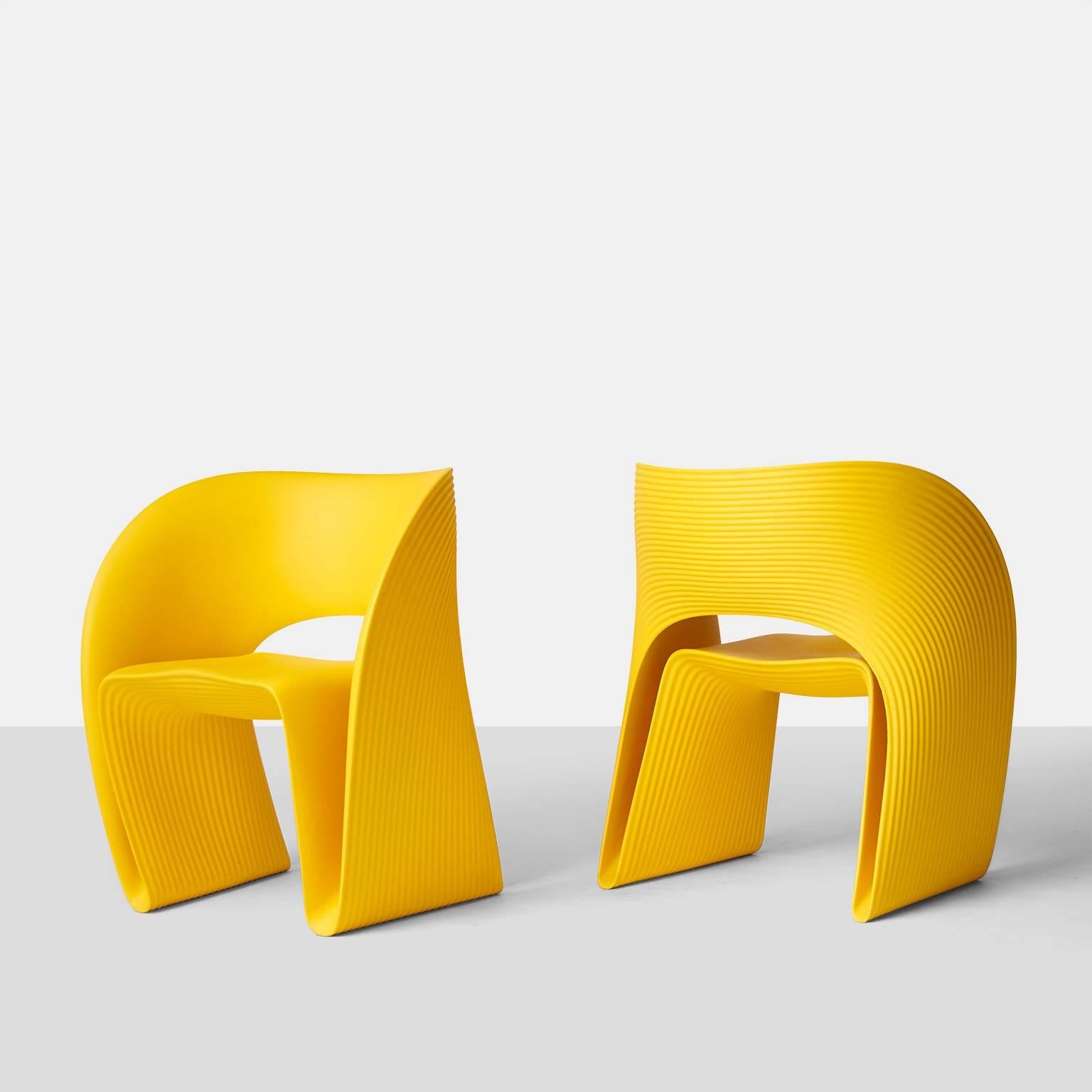 A pair of Raviolo lounge chairs designed by Ron Arad for Driade in 2011. Made of rotational-molded polyethlene. The curvy design is made from one continuously looped ribbon like band that forms the lounge chair. The ridged outer texture was intended