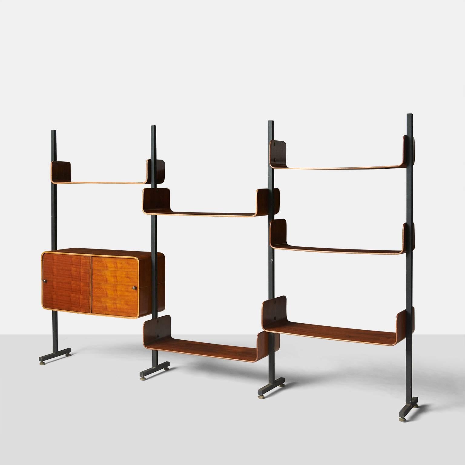 A bookshelf with three sections by Campo Graffi, circa 1950. The bookshelf has a storage area with sliding doors and six shelves made of curved rosewood veneer, all are attached to a black iron frame. Original manufacturers label on the