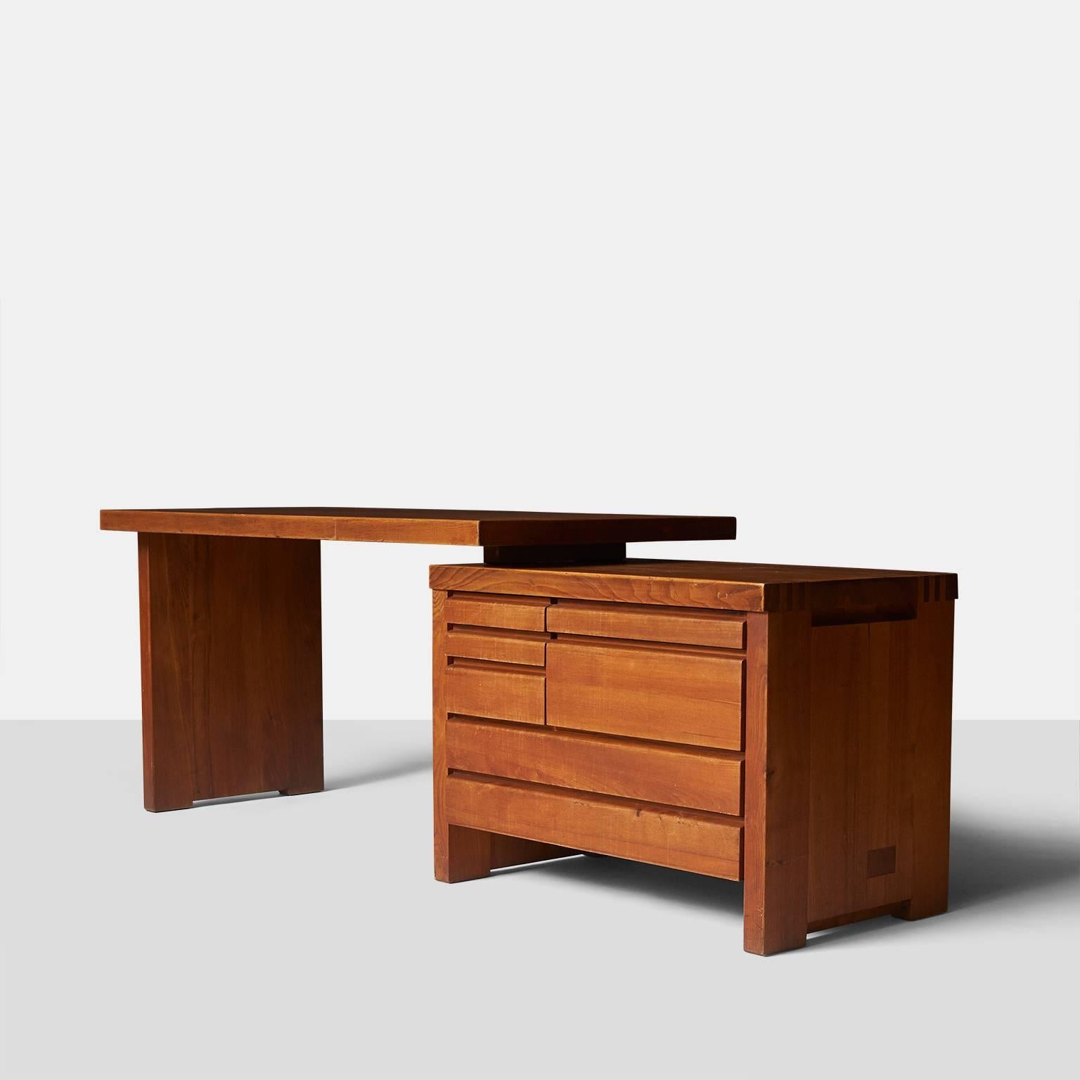 A solid elmwood desk with wood dowels by Pierre Chapo, France, circa 1960s. The desk top floats over the chest that has three pencil drawers, three deeper drawers and one file drawer. The desk top can be placed to the left or right and also on an