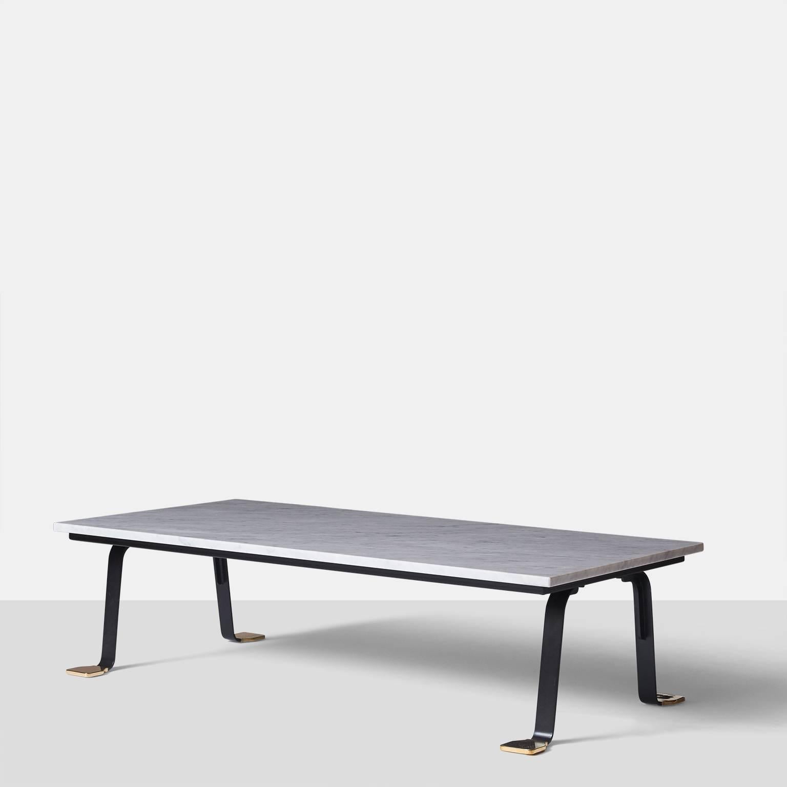 A rectangular coffee table with a Carrara marble top, black metal frame and polished brass feet. Made in Bolognesi Workshops, circa 2014.

