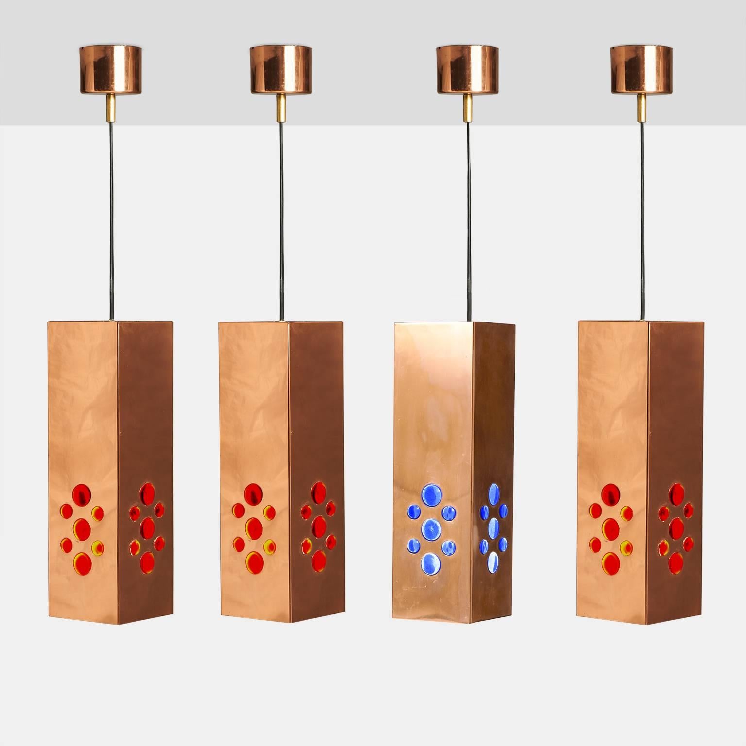 A set of four copper pendants with inset glass beads of red and blue designed by Hans Agne Jakobssen for for Markaryd. Each pendant has a single socket where the light reflects down and through the glass bead.

Price is for all 4 pendants.