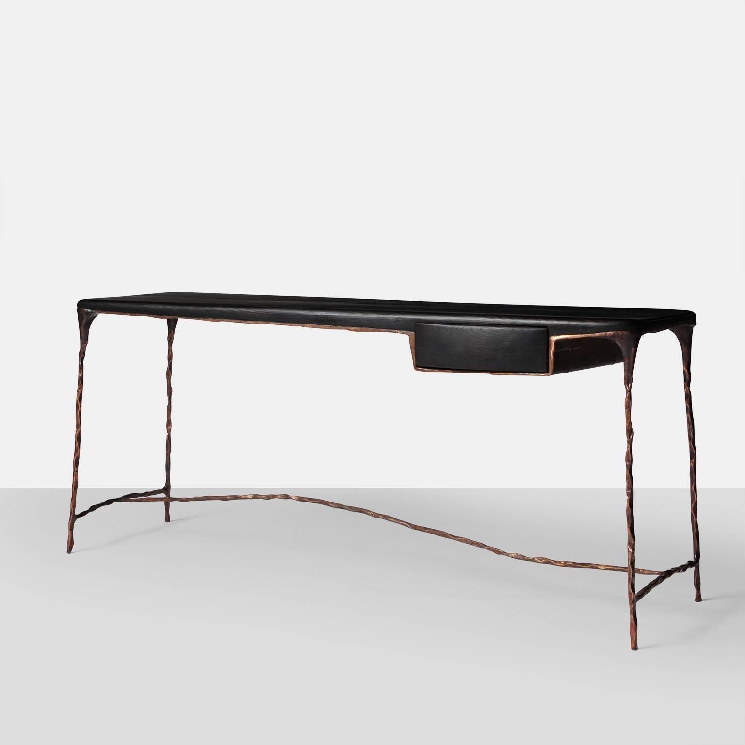 A copper frame desk with a blackened oak top and a single drawer. Completely handmade and all copper work has been hand-forged with exceptional detail on the underside. Opposite side of desk has a false drawer so that it can view from both sides. 
