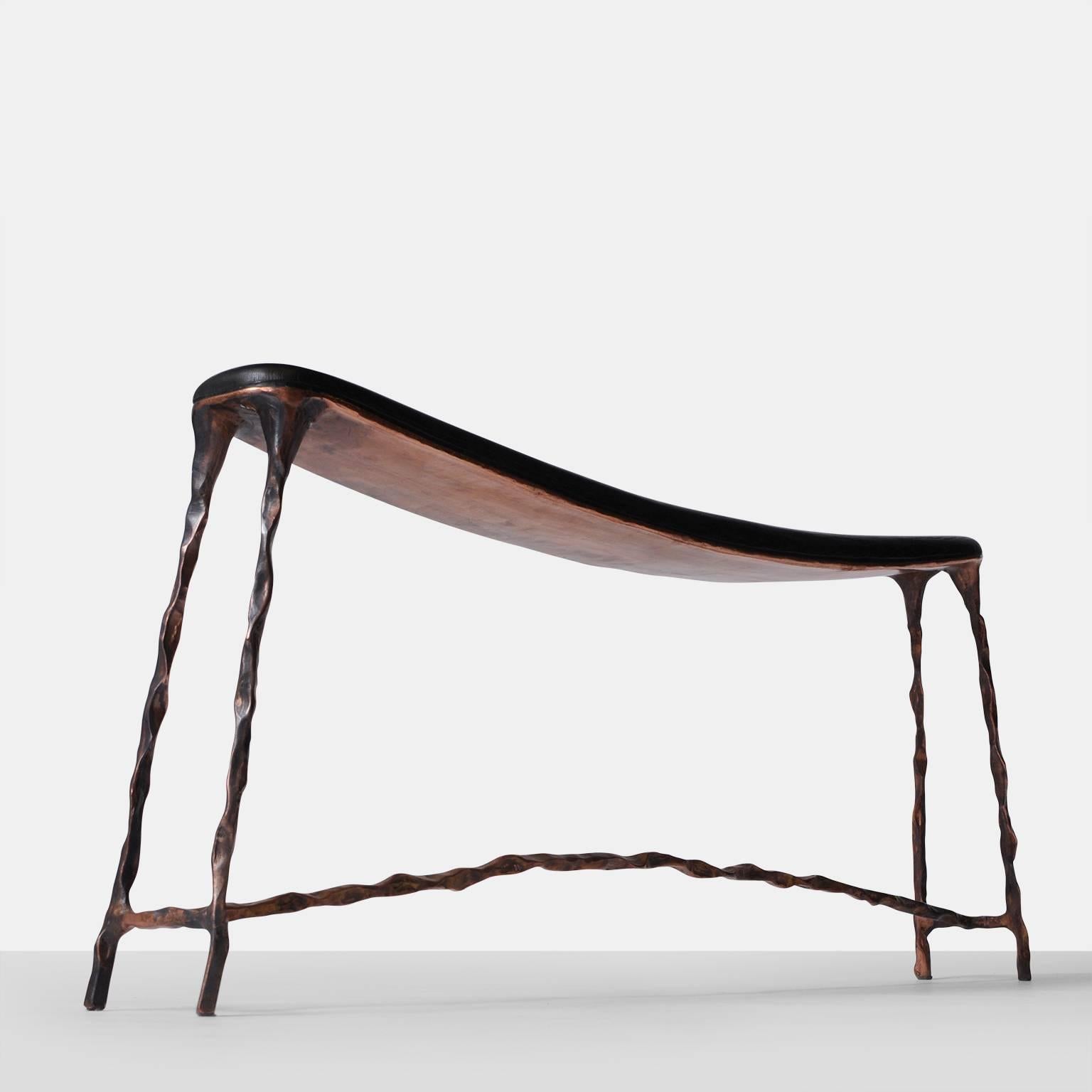 A small-scale bench with a bended and blackened oak top and a base of hand-forged copper. Each piece is completely handmade by Valentin Loellmann and all are a limited edition, signed and numbered. Almond & Company is the exclusive gallery