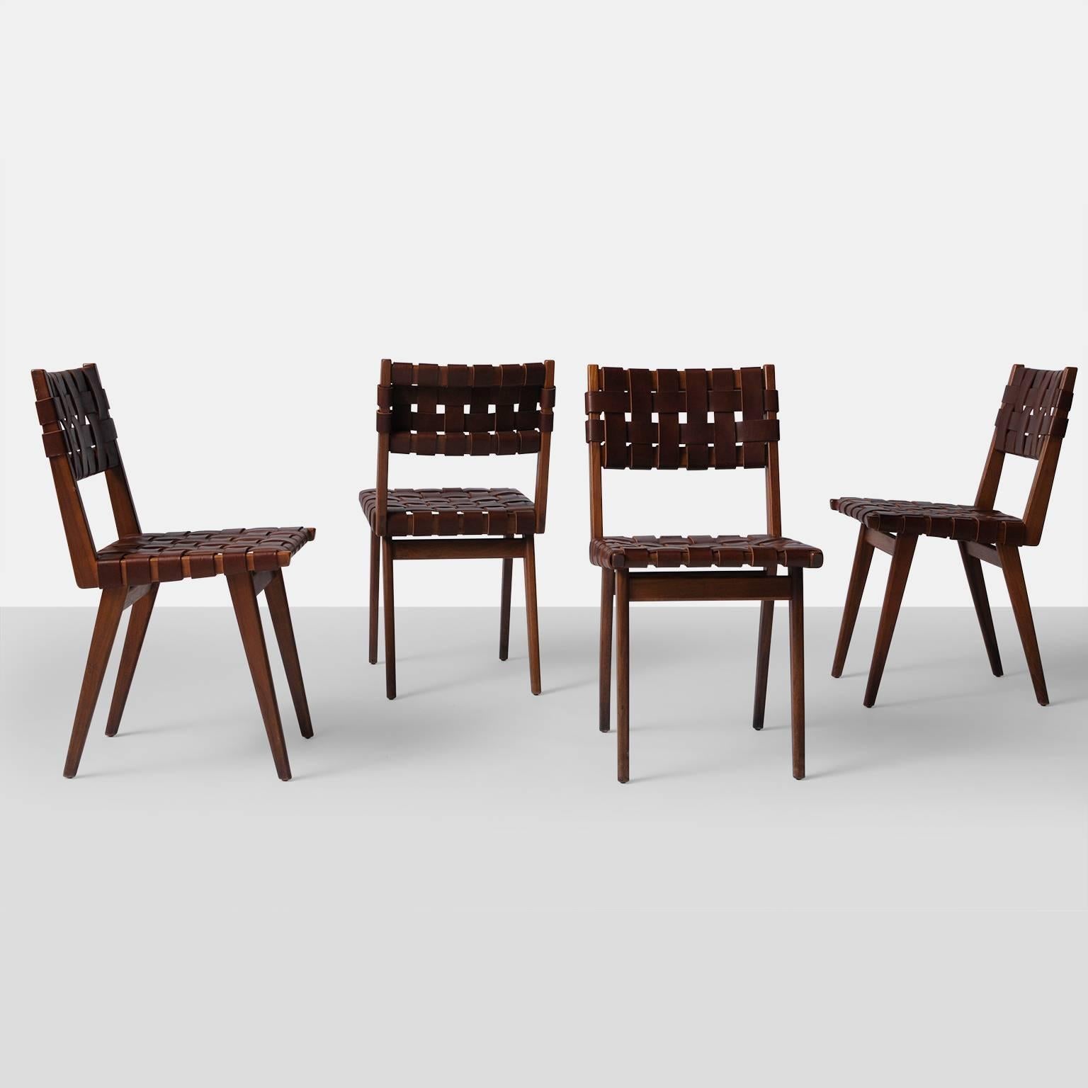 A set of four Jens Risom oak side chairs with brown leather webbing, circa 1950s.