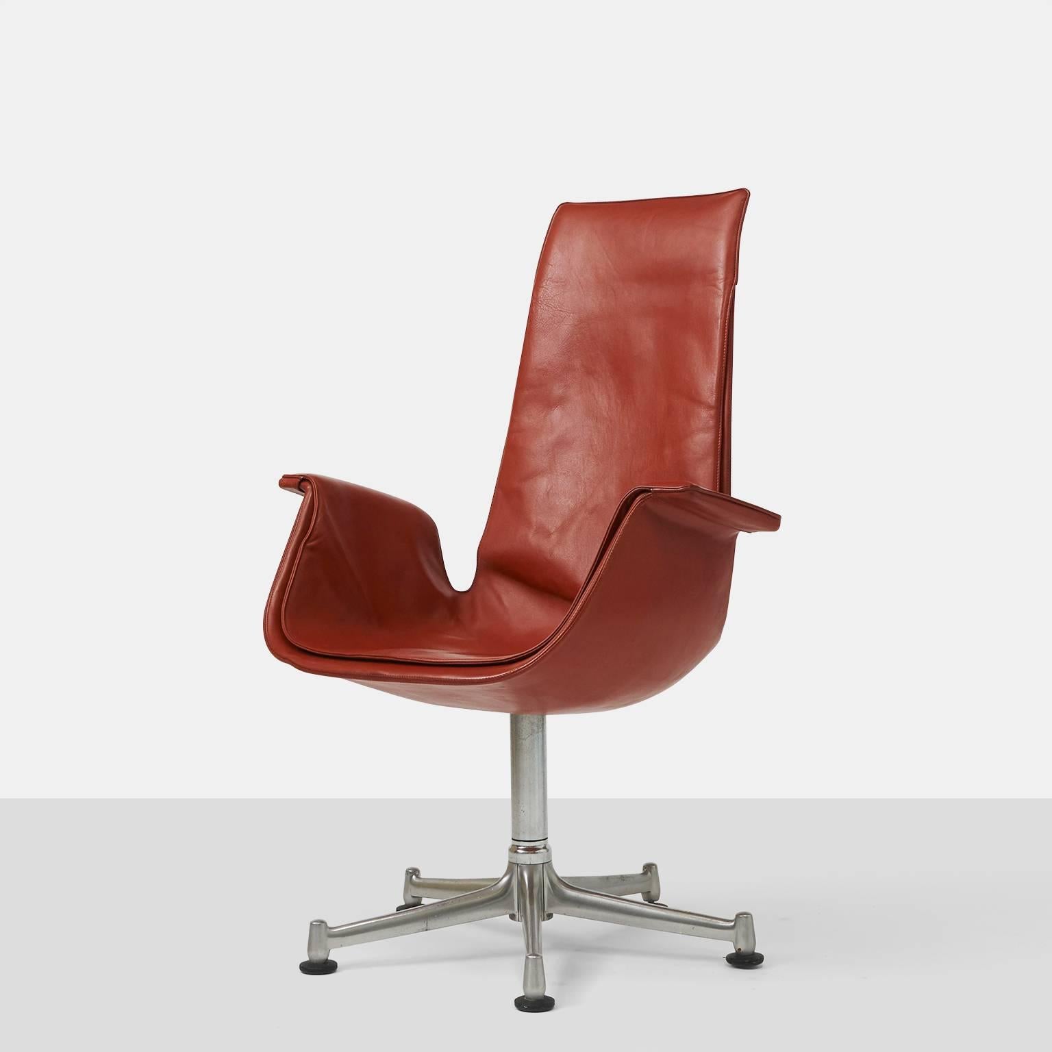 A cordovan leather swivel chair by Preben Fabricius & Jorgen Kastholm for Alfred Kill International. Marked with label underneath.