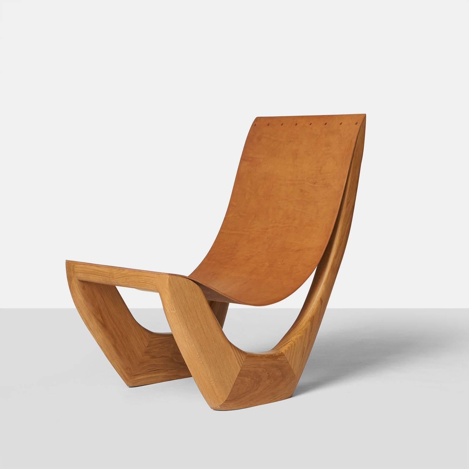 A lounge chair made of naturally fallen oak with a solid leather strap. Almond & Company is the exclusive gallery in the U.S. to represent this artist.