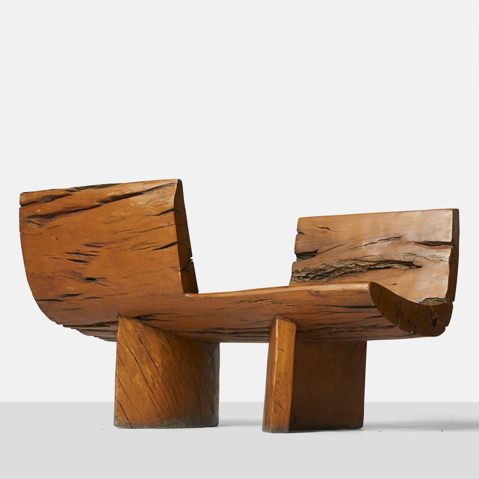 A tete a tete by Hugo Franca made of naturally fallen Brazilian hardwood trees. The design is made of opposing seats on two semi circular bases,
Brazil, circa 1990.