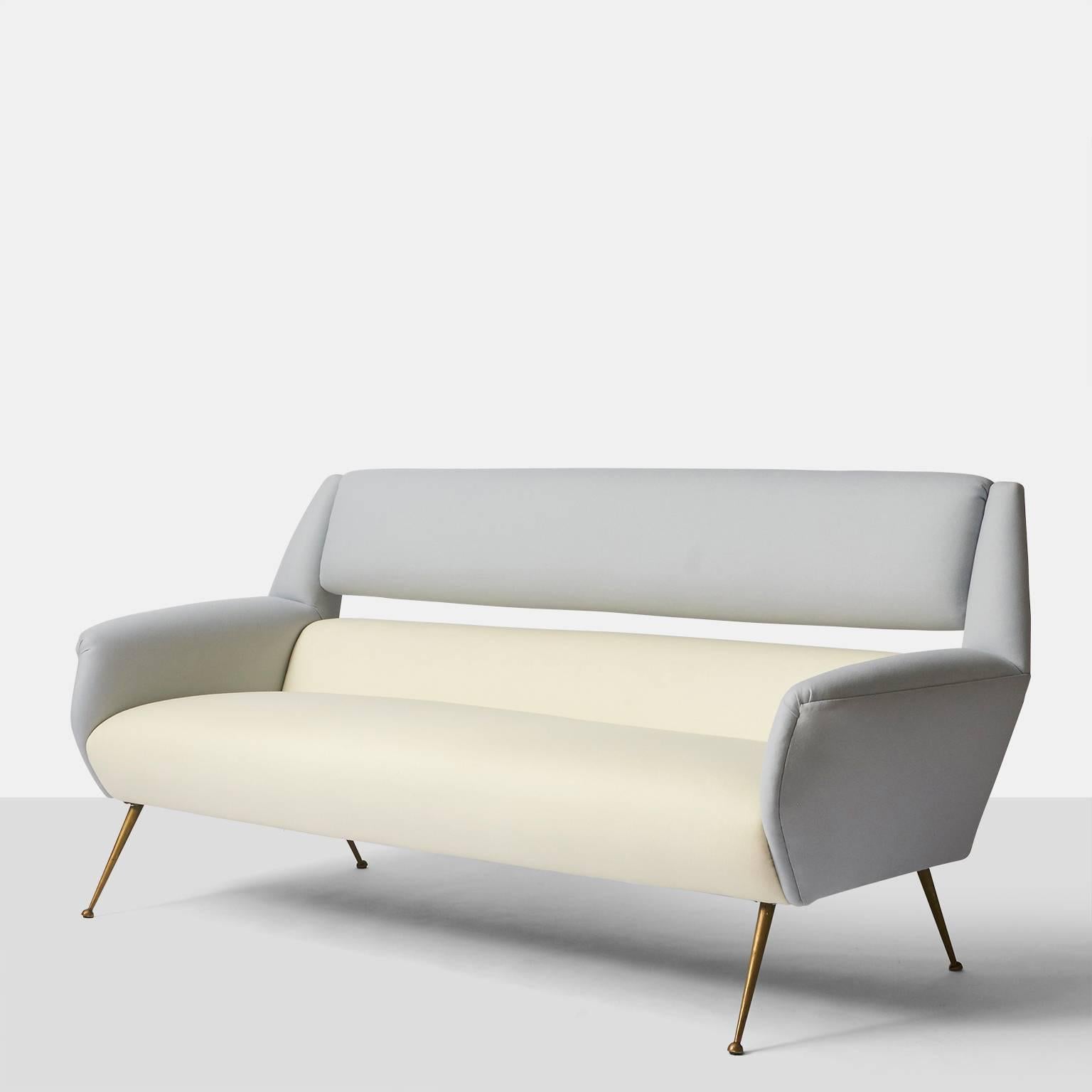 A sofa with tapered brass legs and a two-tone wool upholstery in ivory and grey, Italy, circa 1950.