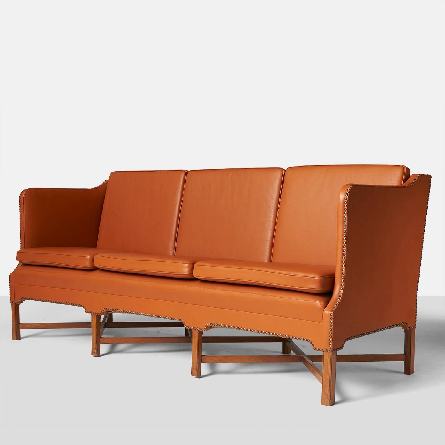 A three seat sofa model #4118 in mahogany with 