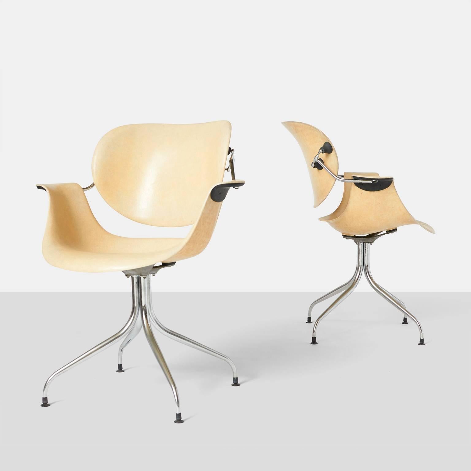 An extremely rare pair of swan leg chairs in fiberglass with chromed base by Herman Miller. The advanced design of the mechanism on outside allows the backrest to move freely form the seat. Retains the original label,
USA, circa 1954.