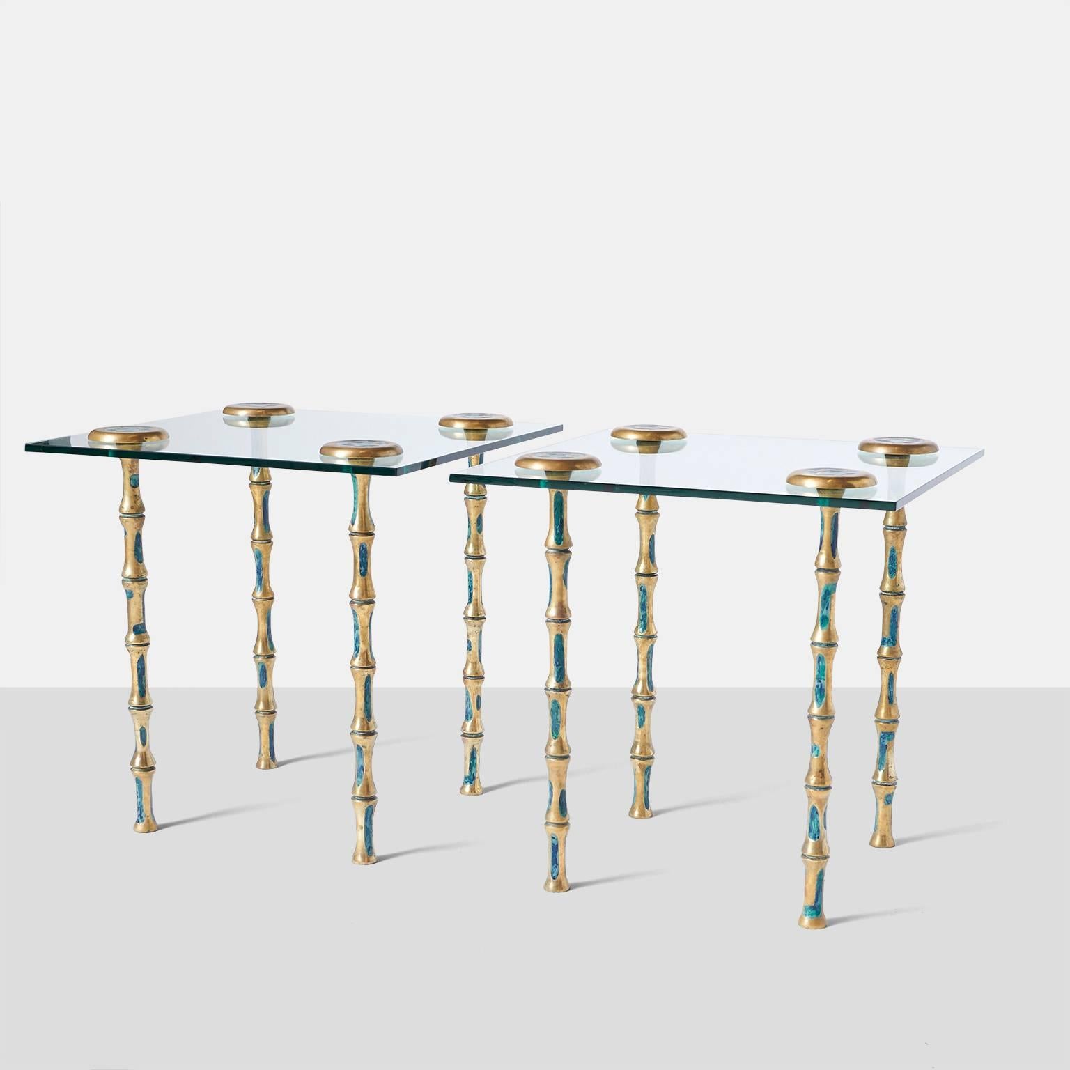 A pair of side or coffee tables with glass top and decorated solid brass legs. The four legs attach thru the glass top with a brass star shaped cap.
Mexico, c. 1950's.