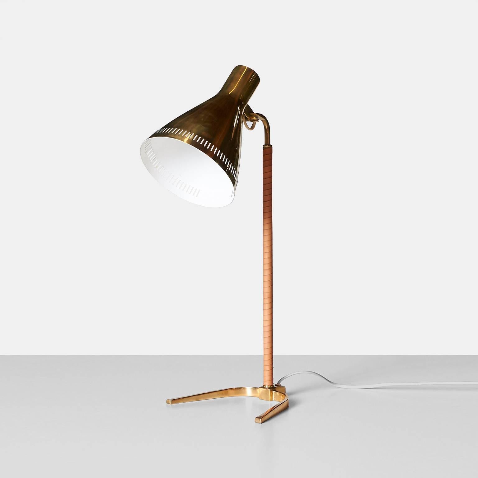 A table lamp model #9224 by Paavo Tynell for Idman Oy, Finland, 1953. The lamp is in solid brass with an adjustable shade and a perforated edge. The stem is wrapped in leather and sits on a horse shoe shaped base.


 