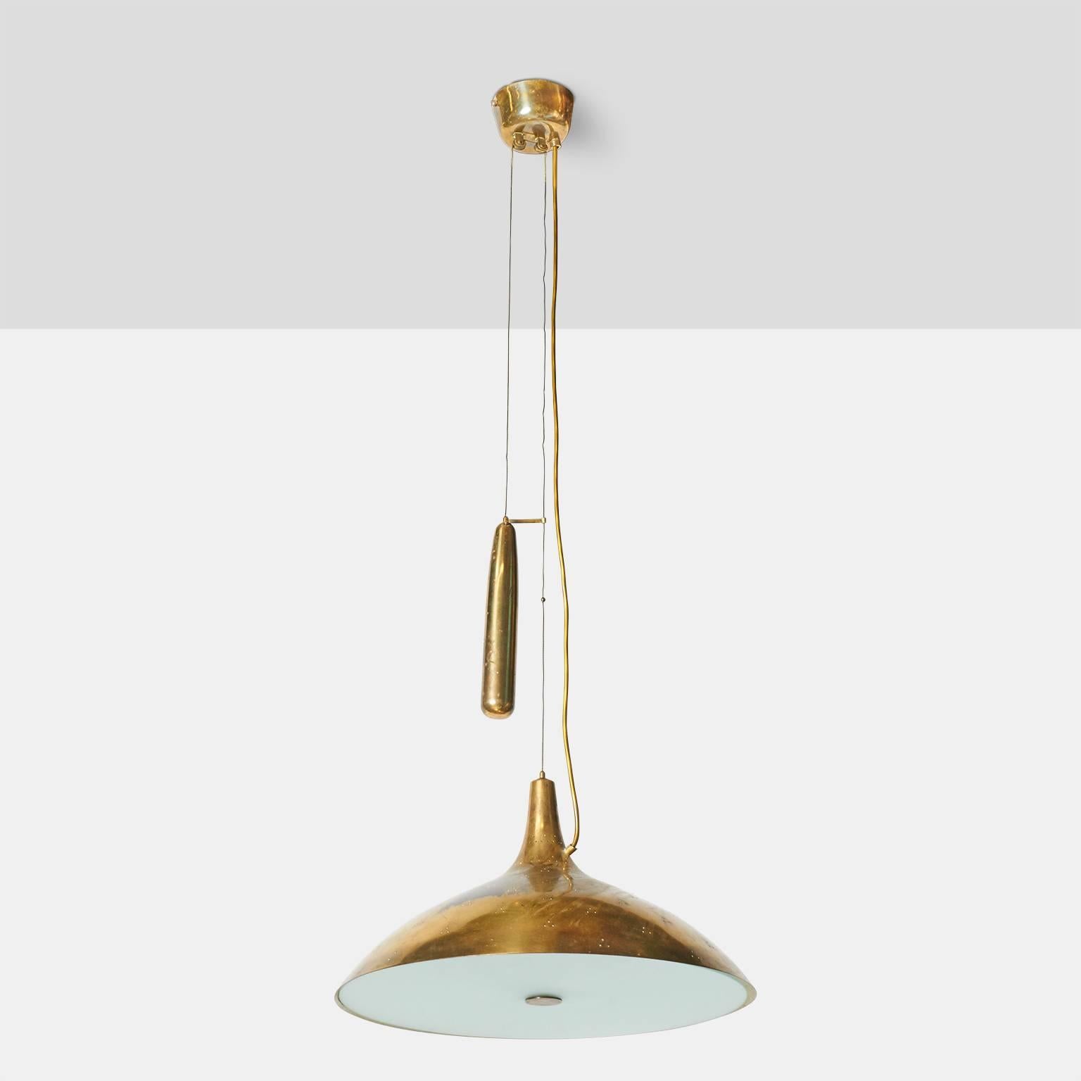 A large-scale counter weight chandelier by Paavo Tynell for Taito Oy. The perforated shade is in brass with a frosted glass diffuser and brass weight for adjusting the overall length,
Finland, circa 1950s.