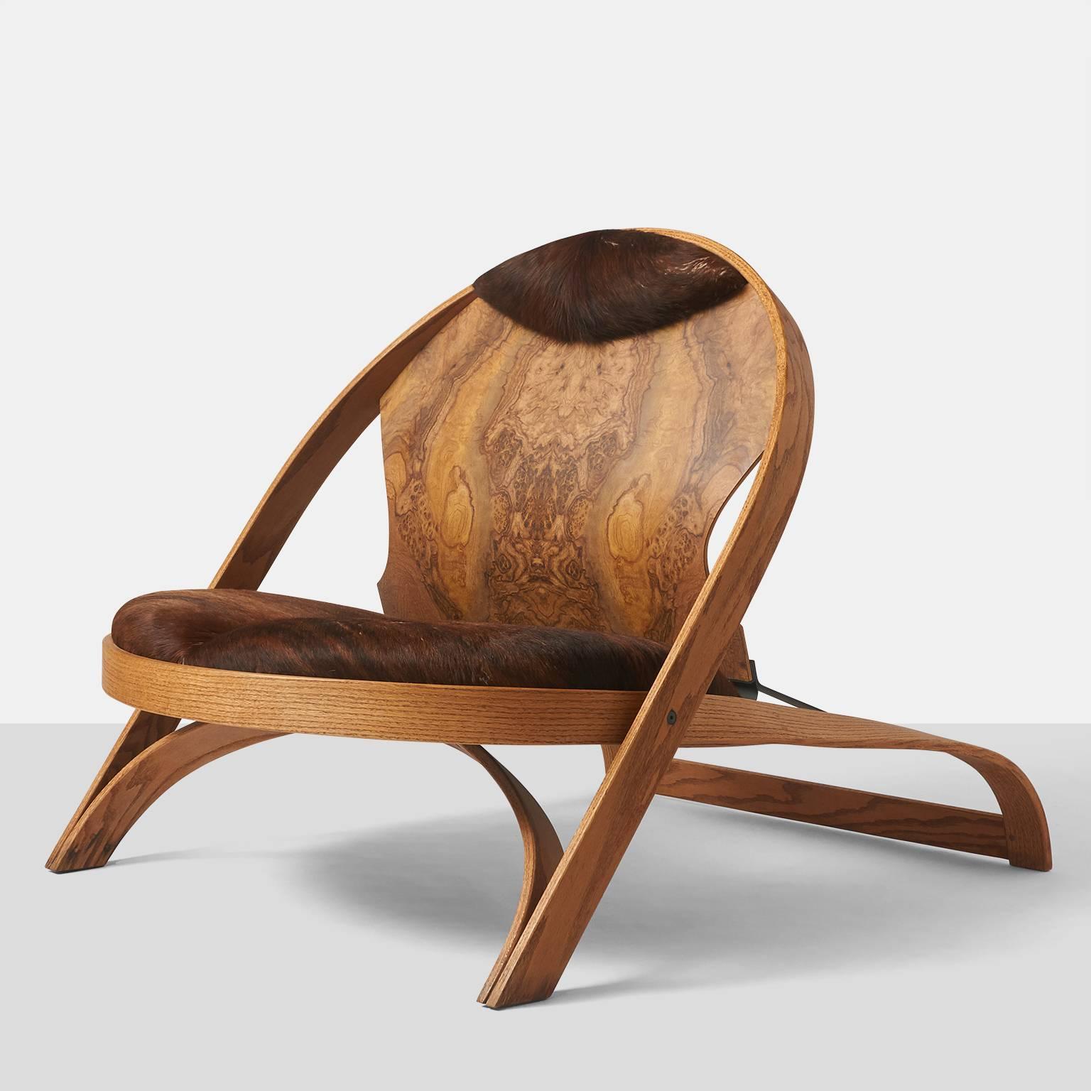 A limited edition chair by Richard Artschwager in oak with cowhide seat and headrest and a painted steel support on the backside.
Richard Artschwager, 1923-2013, is a renowned artist with shows from the Whitney Museum in New York to the Centre