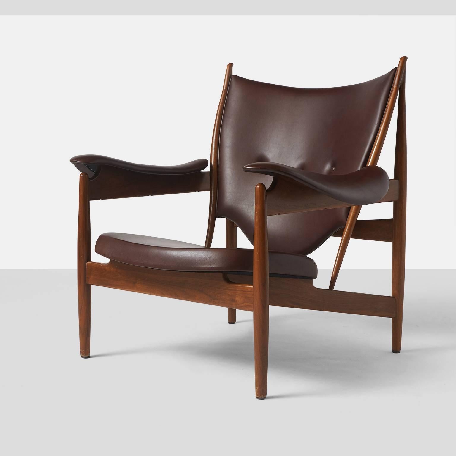 A chieftain chair by Finn Juhl designed in 1951 and manufactured by Baker Furniture in the late 20th century. The chair is upholstered in a deep chocolate color leather on teak frame. The chieftain chair is no longer in production.
