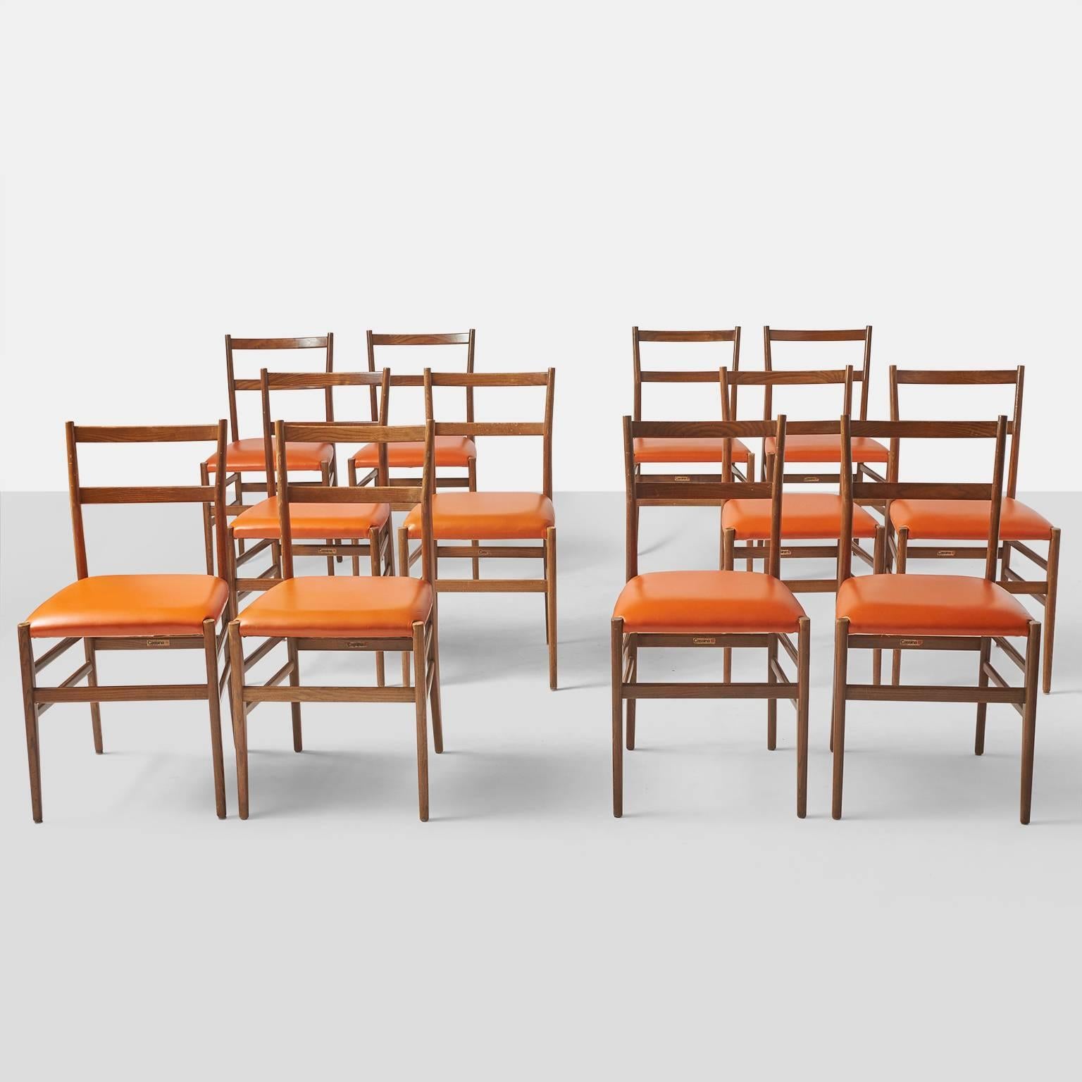 A set of 12 Leggera chairs by Gio Ponti for Cassina retaining the original labels. Seats have been upholstered in an orange faux leather and the frames are in a light ash.
Note: Chairs are priced and sold in sets of 2 chairs.