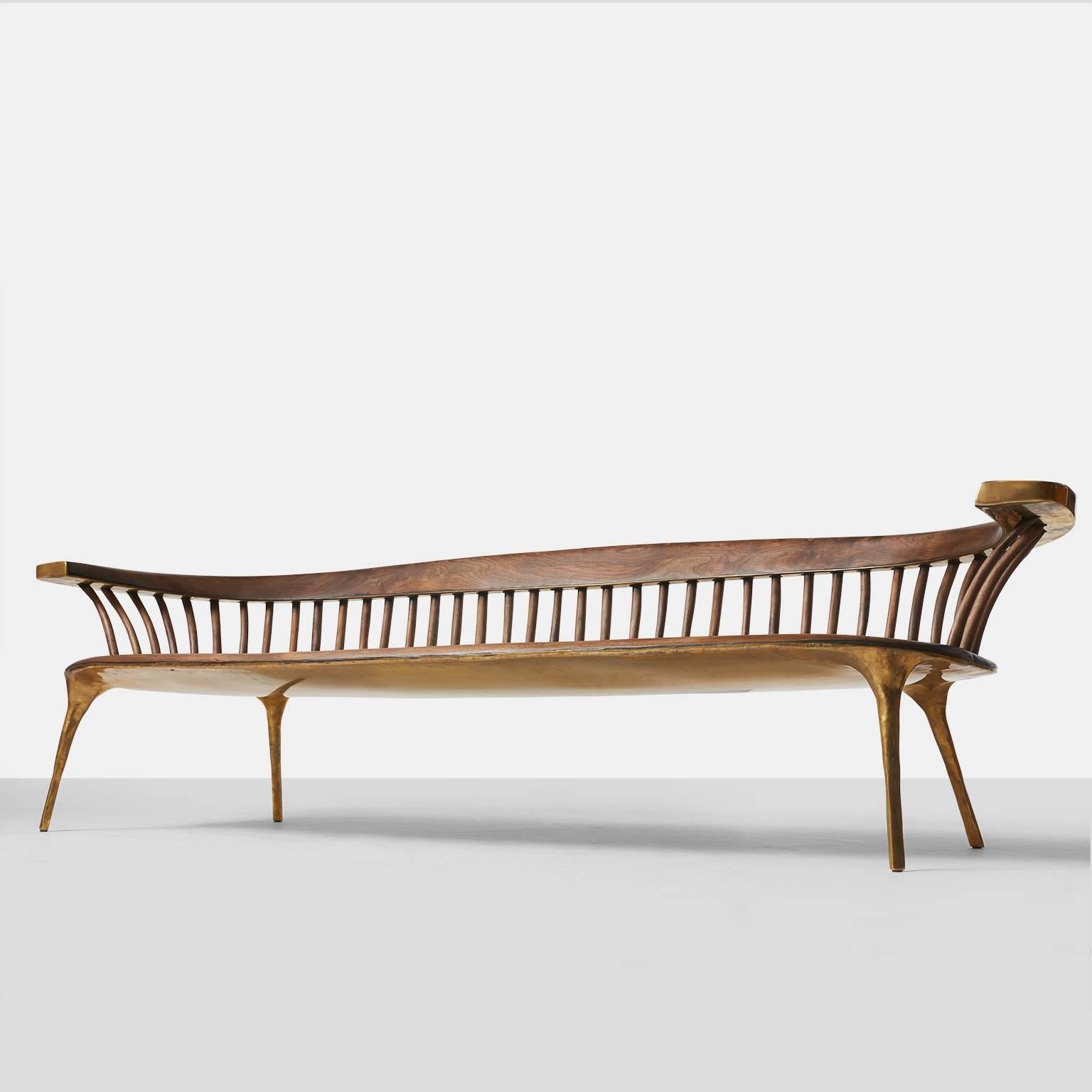 A completely handmade sculptural sofa in solid brass with a walnut seat and back support. All brass work is hand-forged and wood work is hand planed. Valentin Loellmann was an award winner at PAD London for Best Contemporary Design piece.