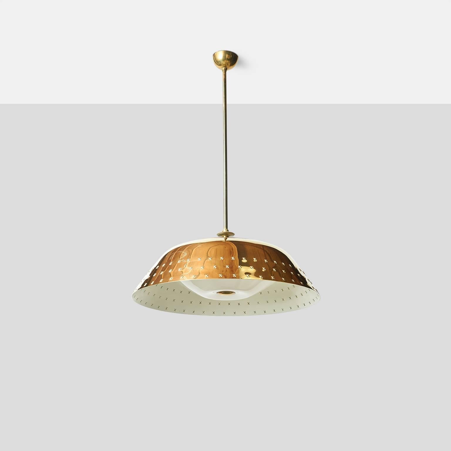 A brass chandelier with perforated X-pattern detail around perimeter, translucent dome covers the bulbs with a brass finial in the center. Manufactured by Orno. 
Finland, circa 1960s.