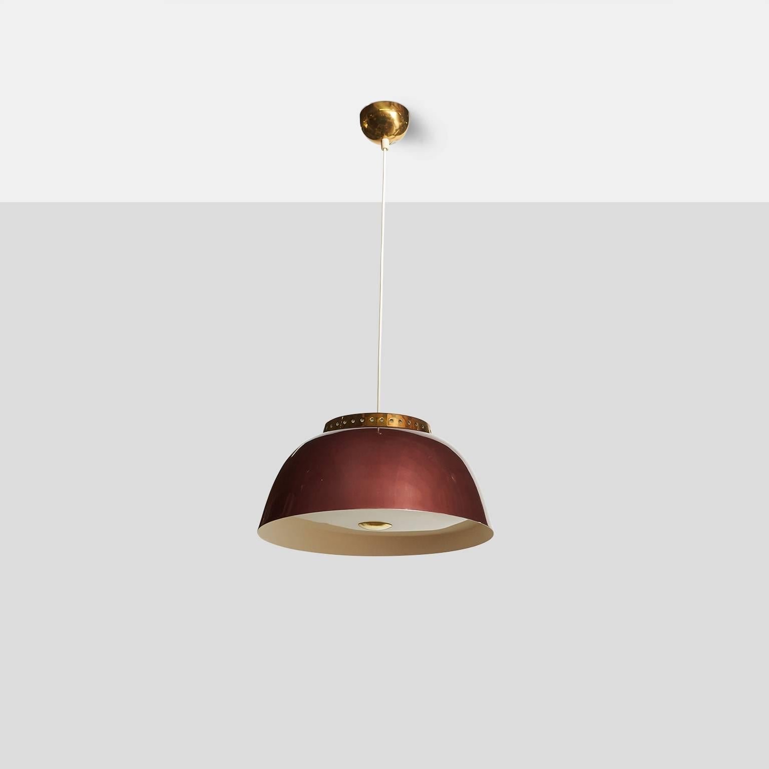 A Lisa Johansson-Pape chandelier model #61-334. Chandelier has pearlescent burgundy metal shade with a perforated brass cap, Opaline glass diffuser on top, and a plexiglass diffuser underneath with brass finial. Marked Orno. Overall length can be