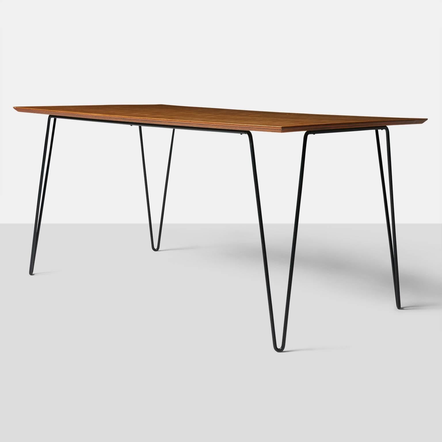 Dining table by Dorothy Schindele.
A rectangular dining table with a pale walnut top, eased edge, and resting on black enameled hair pin legs.
USA, circa 1950s.