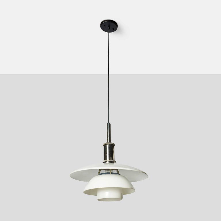 A chrome PH-4.5/4 pendant lamp by Poul Henningsen for Louis Poulson with white-lacquered aluminum top shade, white opal glass lower shades, matt glass lower bowl and chromed metal socket cover, produced by Louis Paulsen.
HOLD OFF- NOT SURE THE