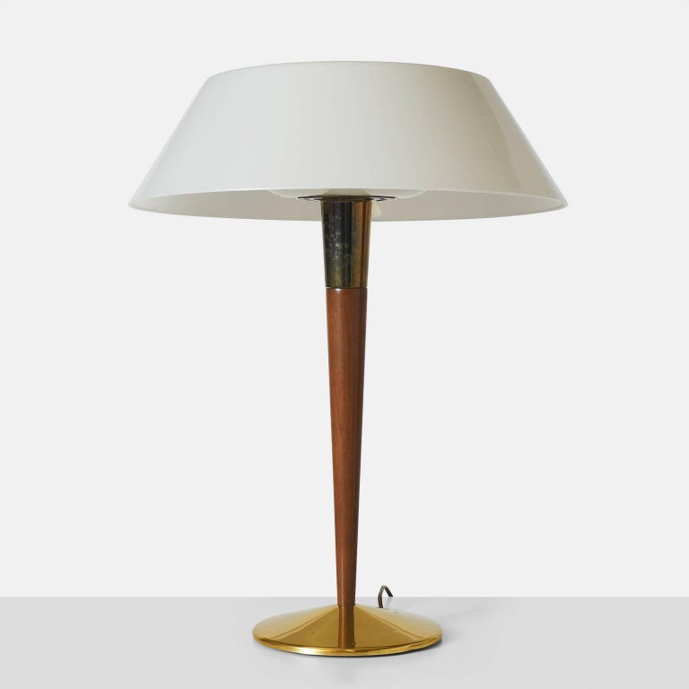 A table lamp in teak and brass, Lightolier #WM6198 by Gerald Thurston. Glass shade.
 