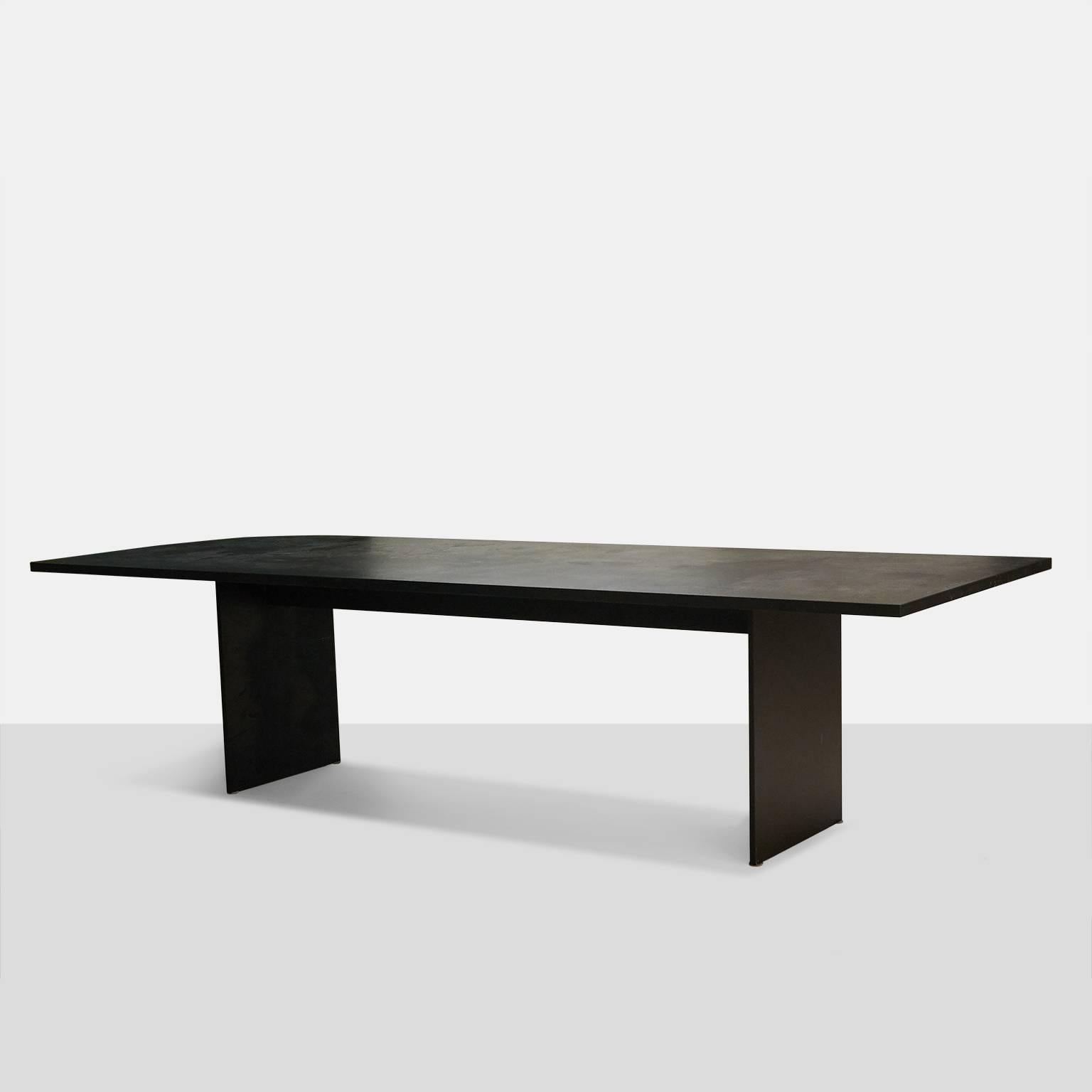 A very large-scale one of a kind dining table created in San Francisco as part of a new collection for Almond & Company. The tabletop is one piece of absolute black granite with a leathered finish over a powder coated solid steel base in black.