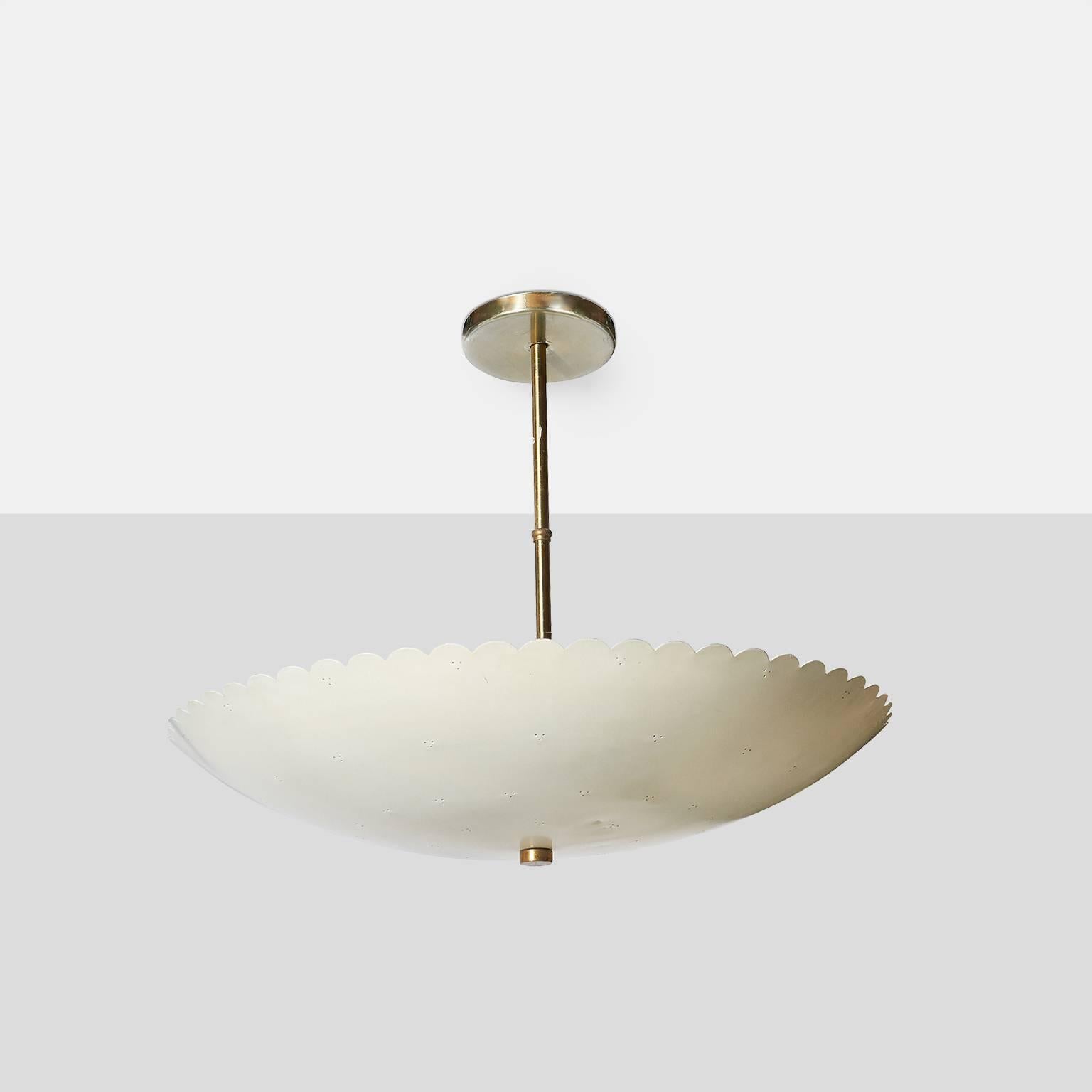 A chandelier by Paavo Tynell for Lightolier with perforated shade and scalloped edge detail.