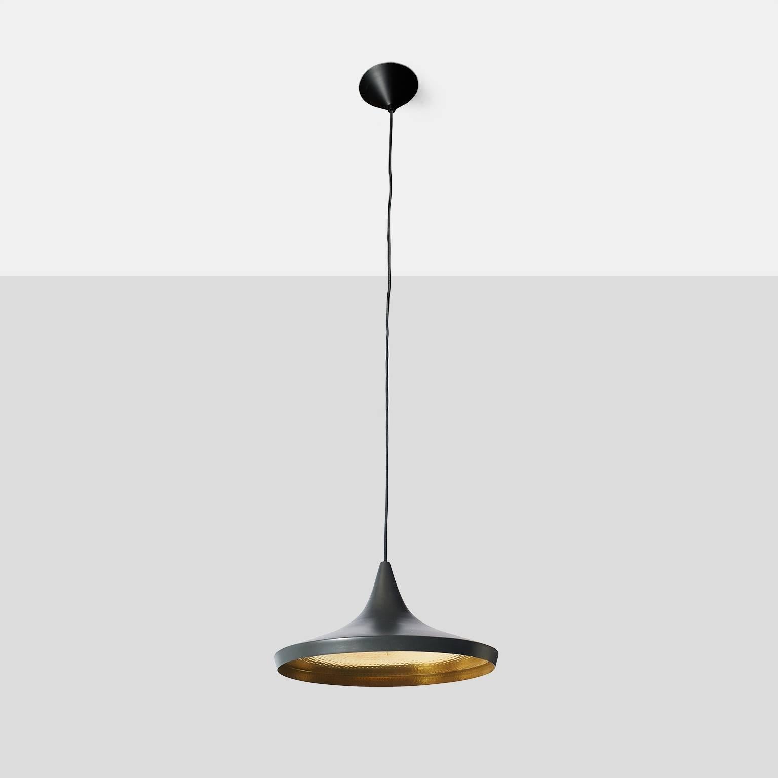 A matte black enameled brass lamp with hand beat detail on brass interior and a smooth exterior. Cord length is 6' and can be adjusted.