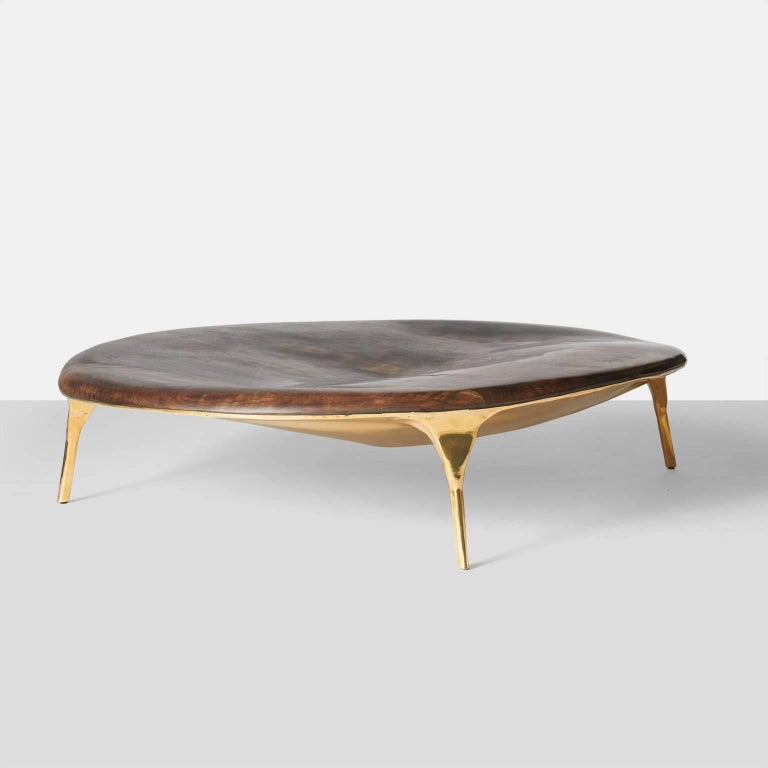 A large-scale low brass and walnut bowl shaped coffee table by furniture designer, and PAD London 2017 winner, Valentin Loellmann. Completely hand constructed from massive brass plates and a walnut top that are merged to create one elegant and