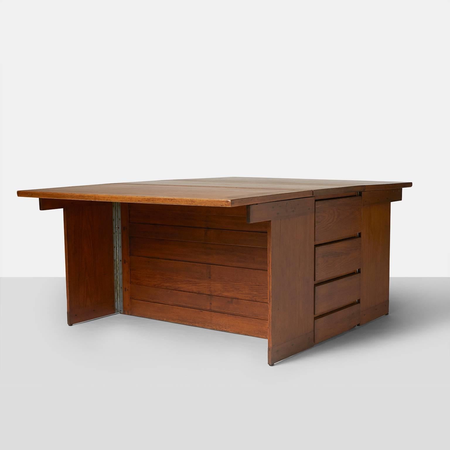 A double-sided drop-leaf partners desk in pine with a bank of four drawers on each side.
Provenance: Descended in the family of the original owner.