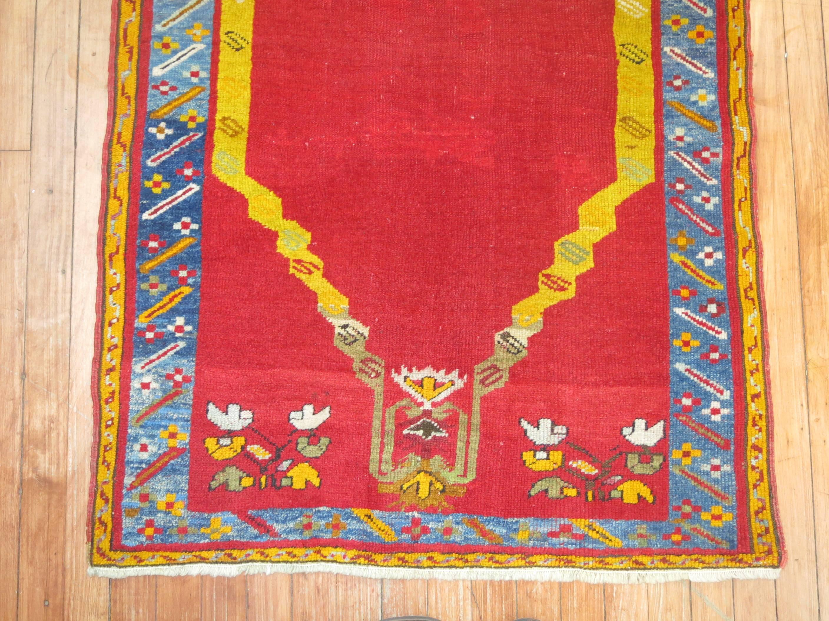 A colorful early 20th century Turkish Melas rug with a Directional prayer motif.