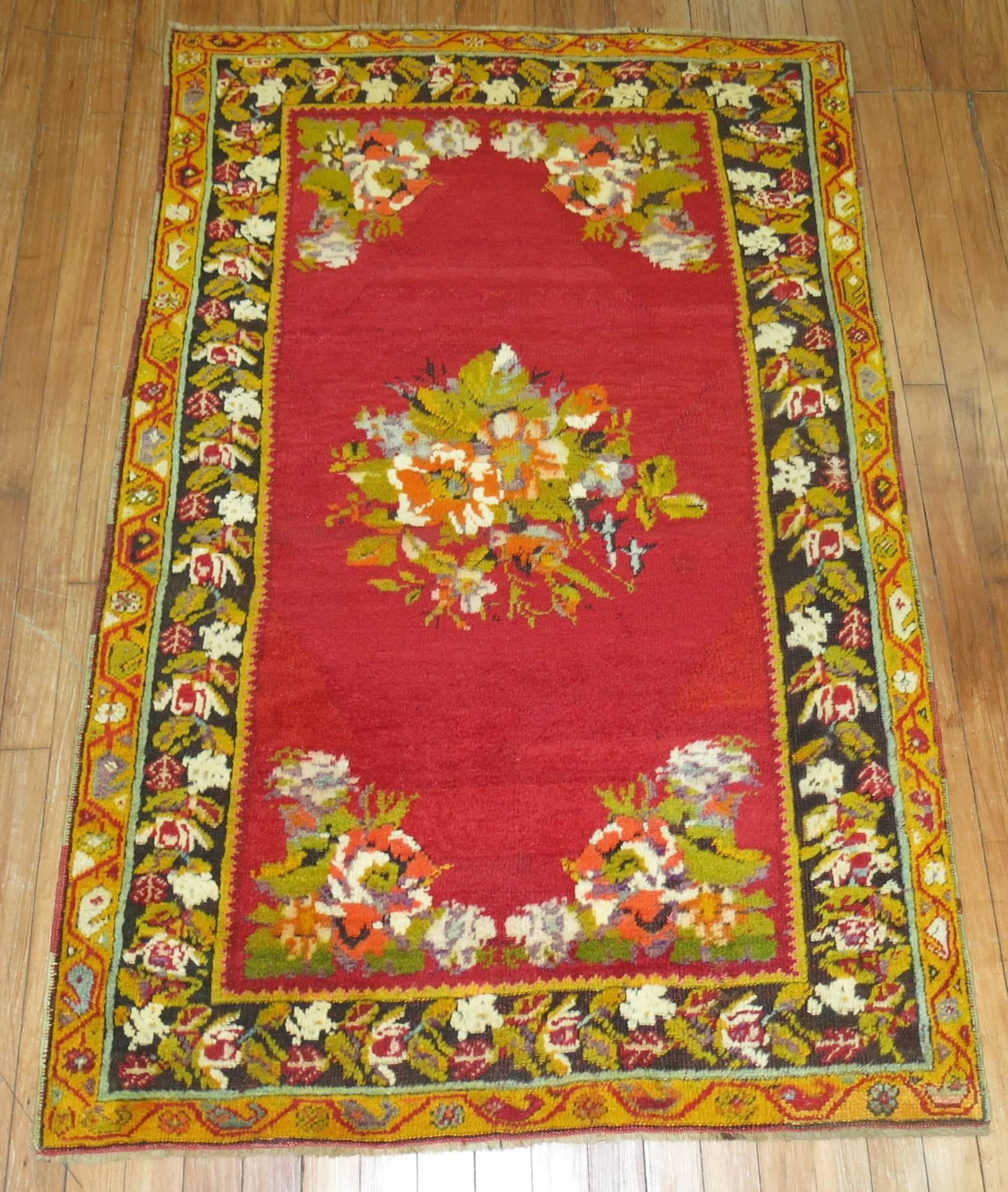 Brightly colored vintage Turkish rug with a floral medallion and border.
