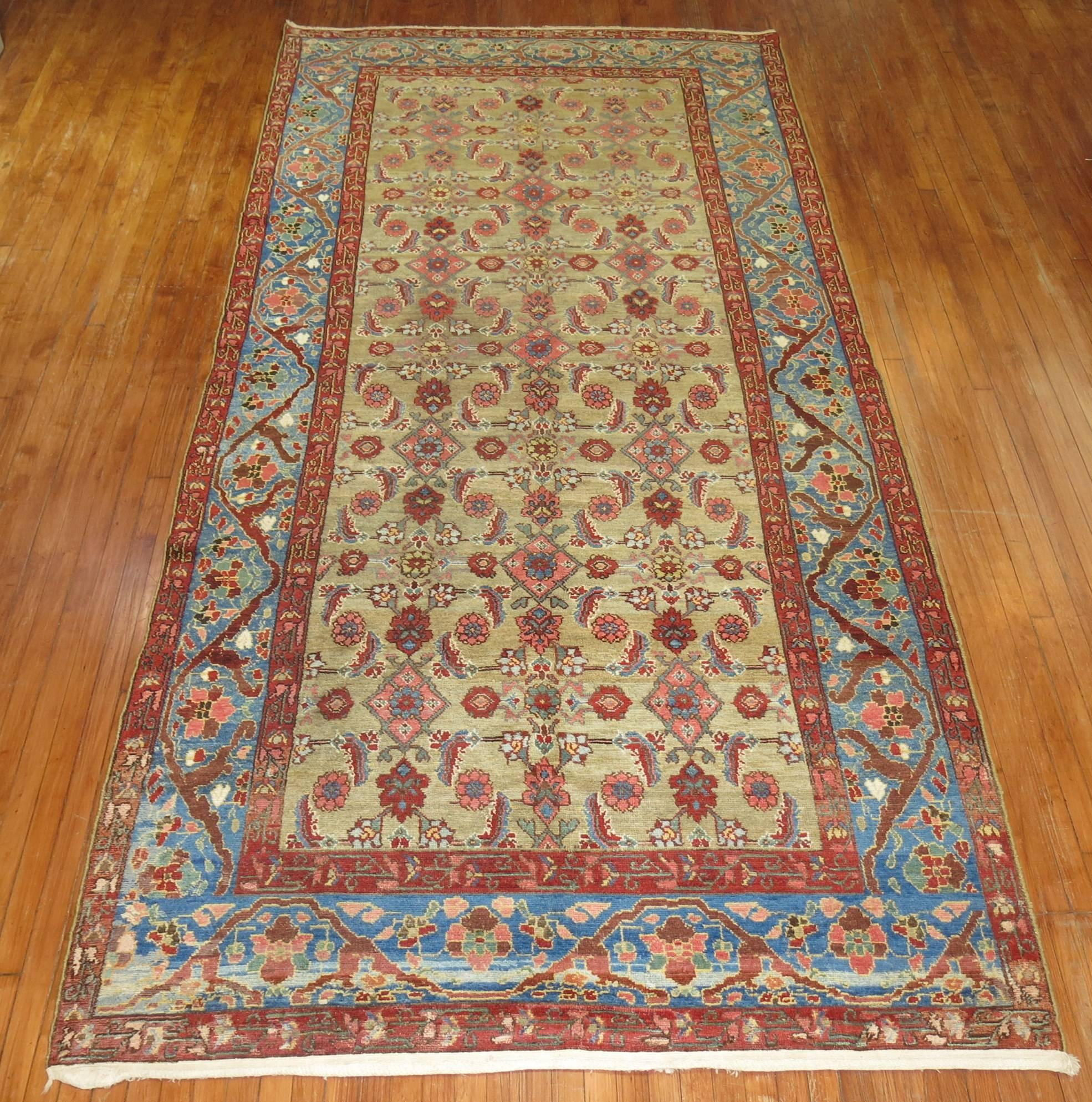 A Persian Malayer gallery size rug with an abrashed sky blue border, camel field and pink herati motifs.