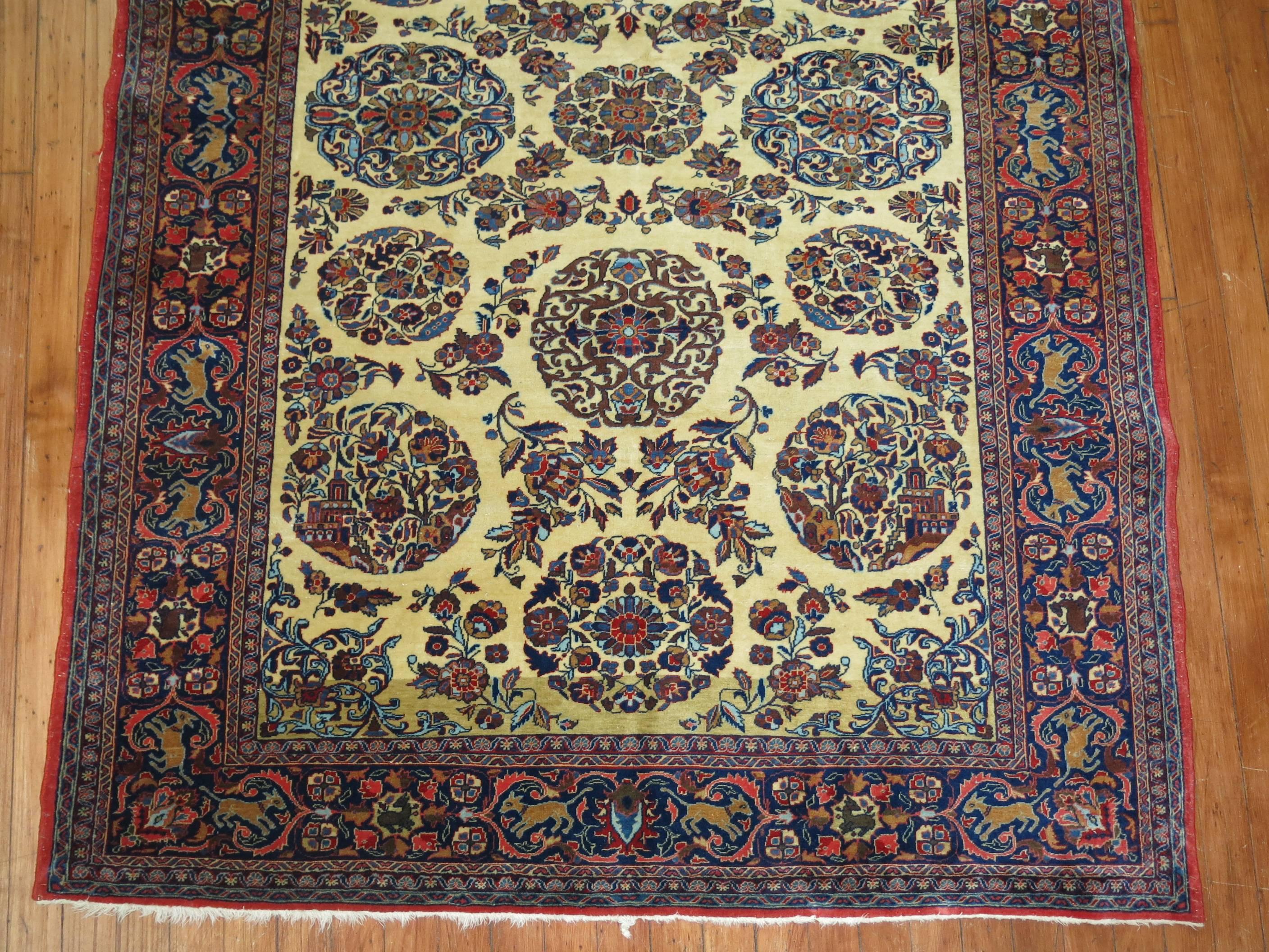 An enchanting early 20th century finely woven Persian Kashan rug with a bone colored field and navy blue pictorial animal border.

4'3'' x 6'6''