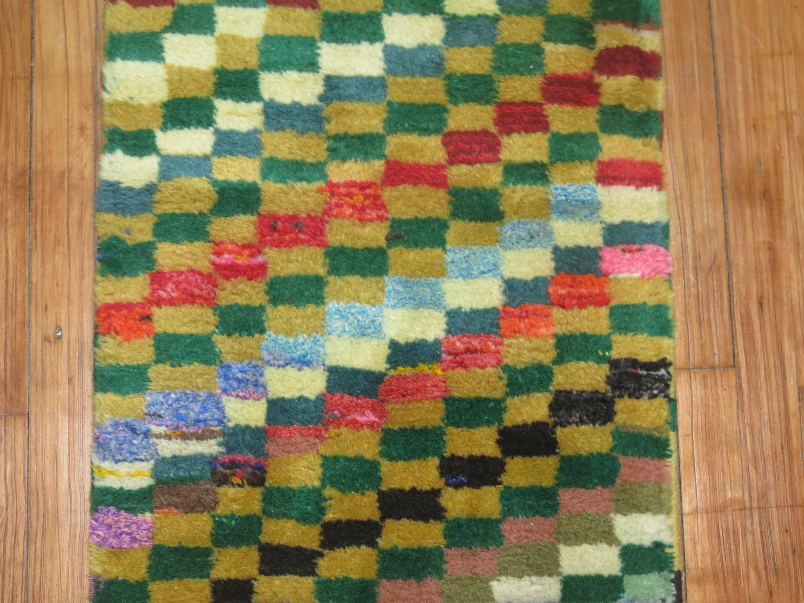 A narrow and long Vintage Turkish Deco runner with a thick pile all over colorful, bright checkerboard motif.

Measures: 1'8'' x 10'7''.
