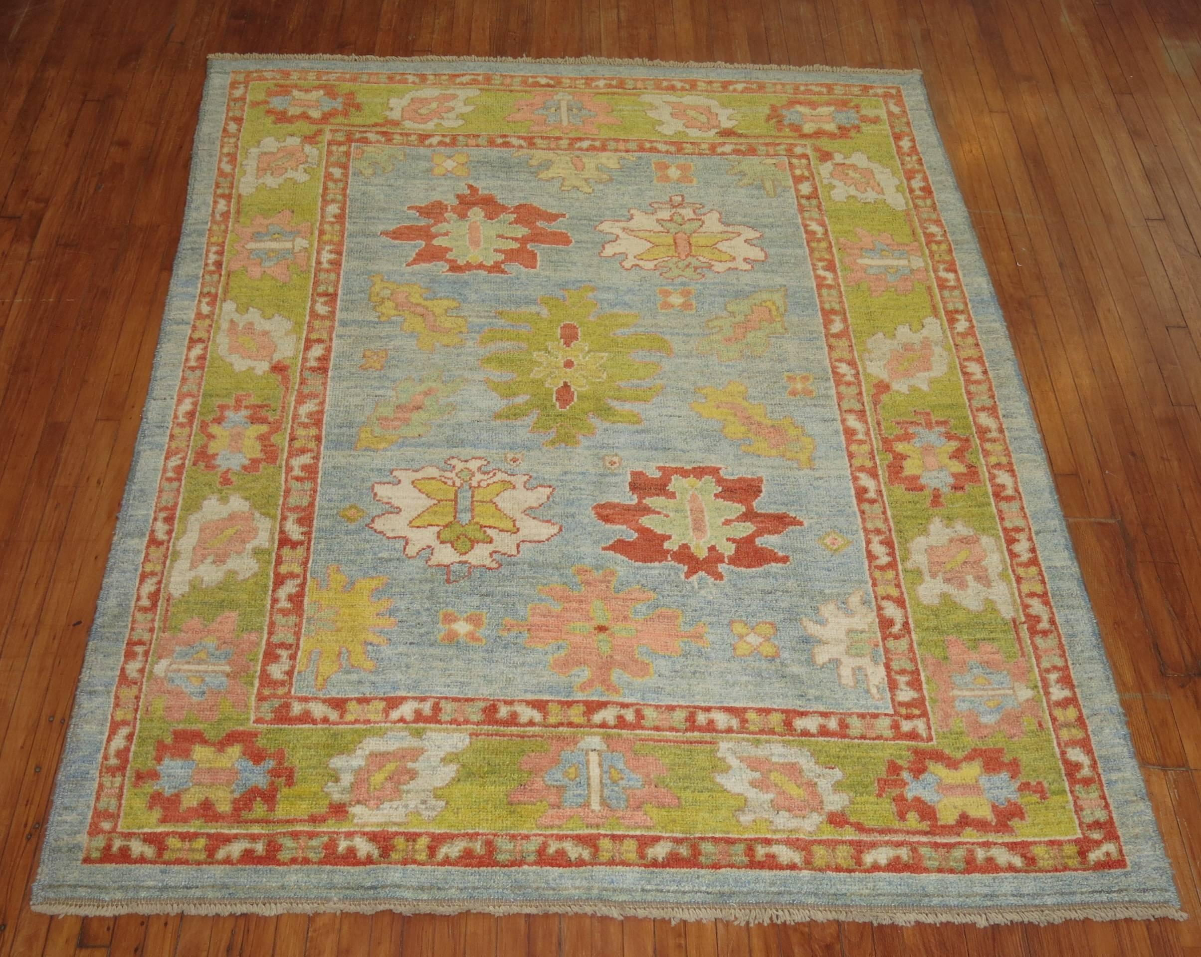 Beautiful one of a kind Turkish Oushak rug in predominant accents in apple green and aqua blue.