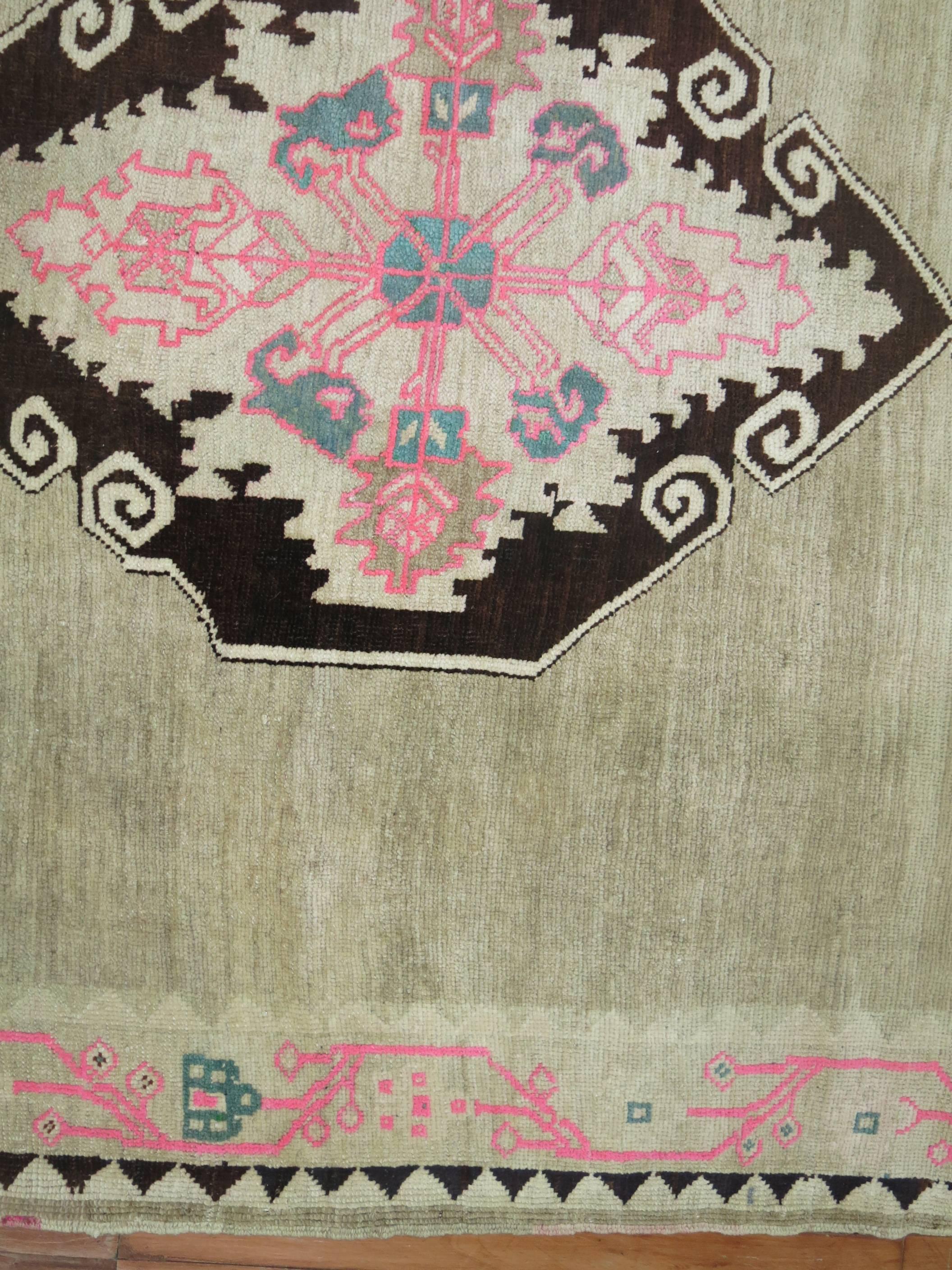 A very unique Turkish Kars rug with four striking medallions in brown and pink surrounded by a wavy pink motif border. 

9'3'' x 10'

Kars is a village located in Northeast of Turkey. The weavers in this area tend to make long runners and long odd