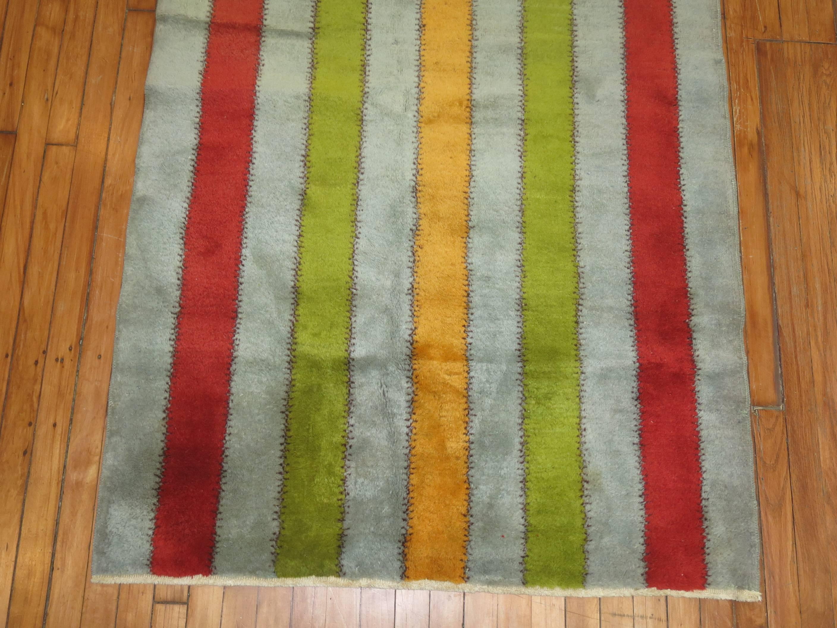 Unusual vintage Turkish rug with a colorful vertical striped motif on a blue field.

Measures: 3'9'' x 6'10''.