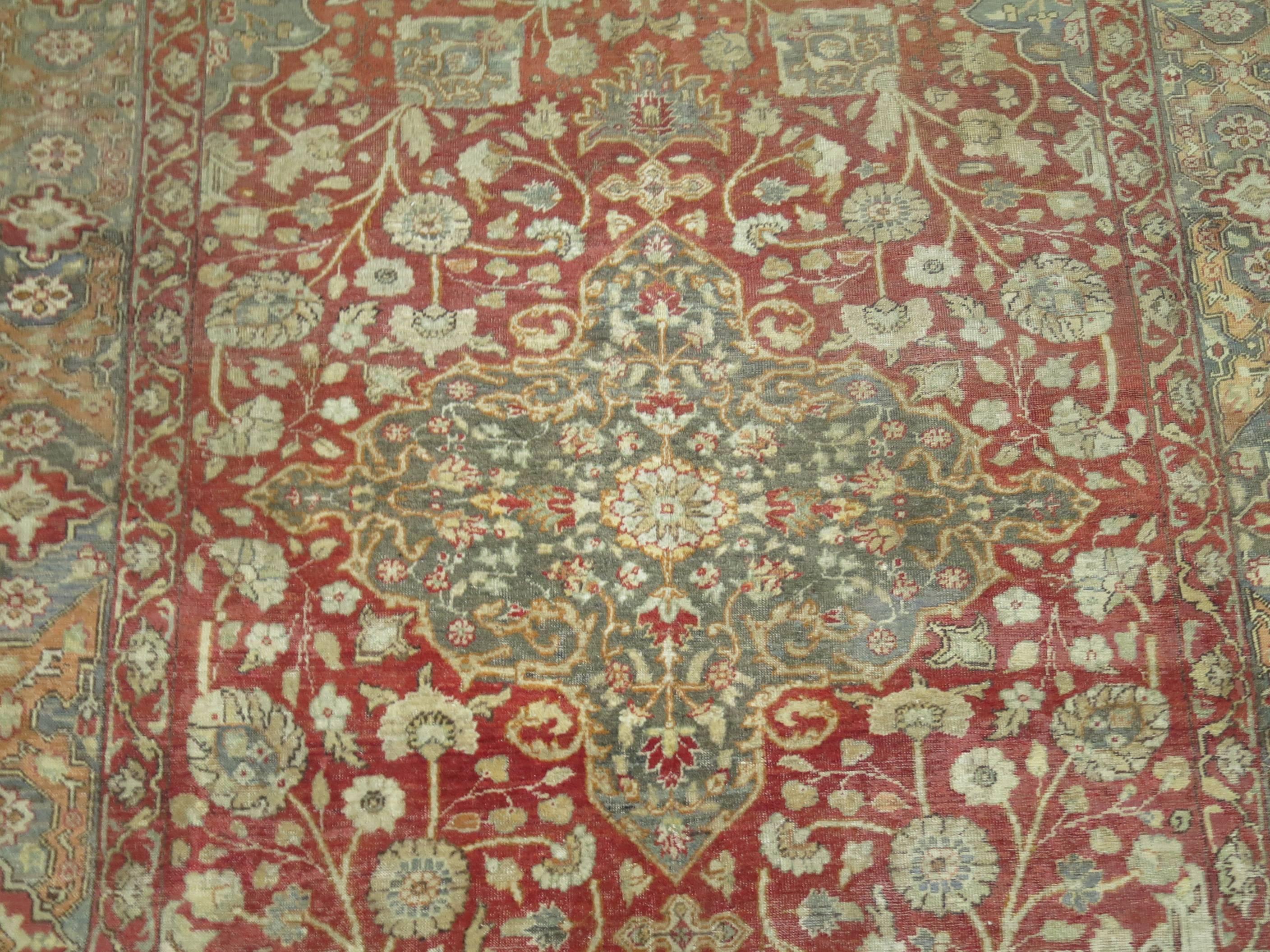 Finely woven Turkish Sivas carpet with Classic medallion and border, predominant color accents in gray and red. Measures: 6'7” x 9'7”.