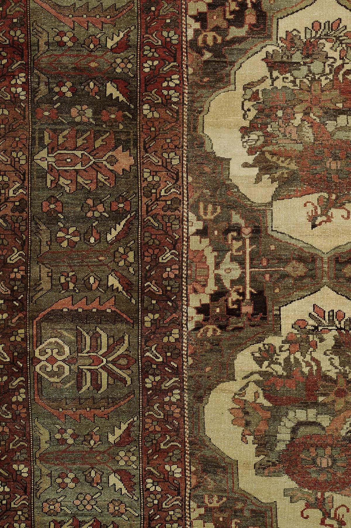 Oversized Persian Bakhtiari carpet with a repetitive all-over floral motif.

Until the 1930s Bakhtiari rugs were characteristically woven for use by the tribe or on commission within Iran. As they were rarely produced to be exported, they offer