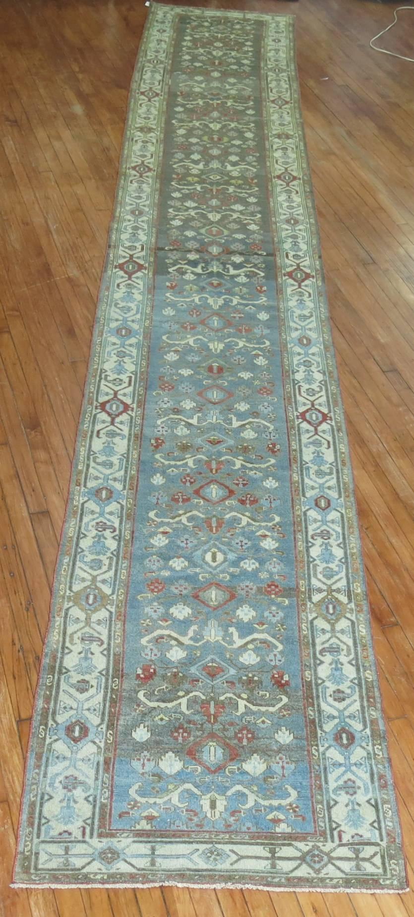 Early 20th century abrashed Persian Malayer runner. Accents in icy blue, green, brown and peppermint red.

Measures: 3' x 19'4''.