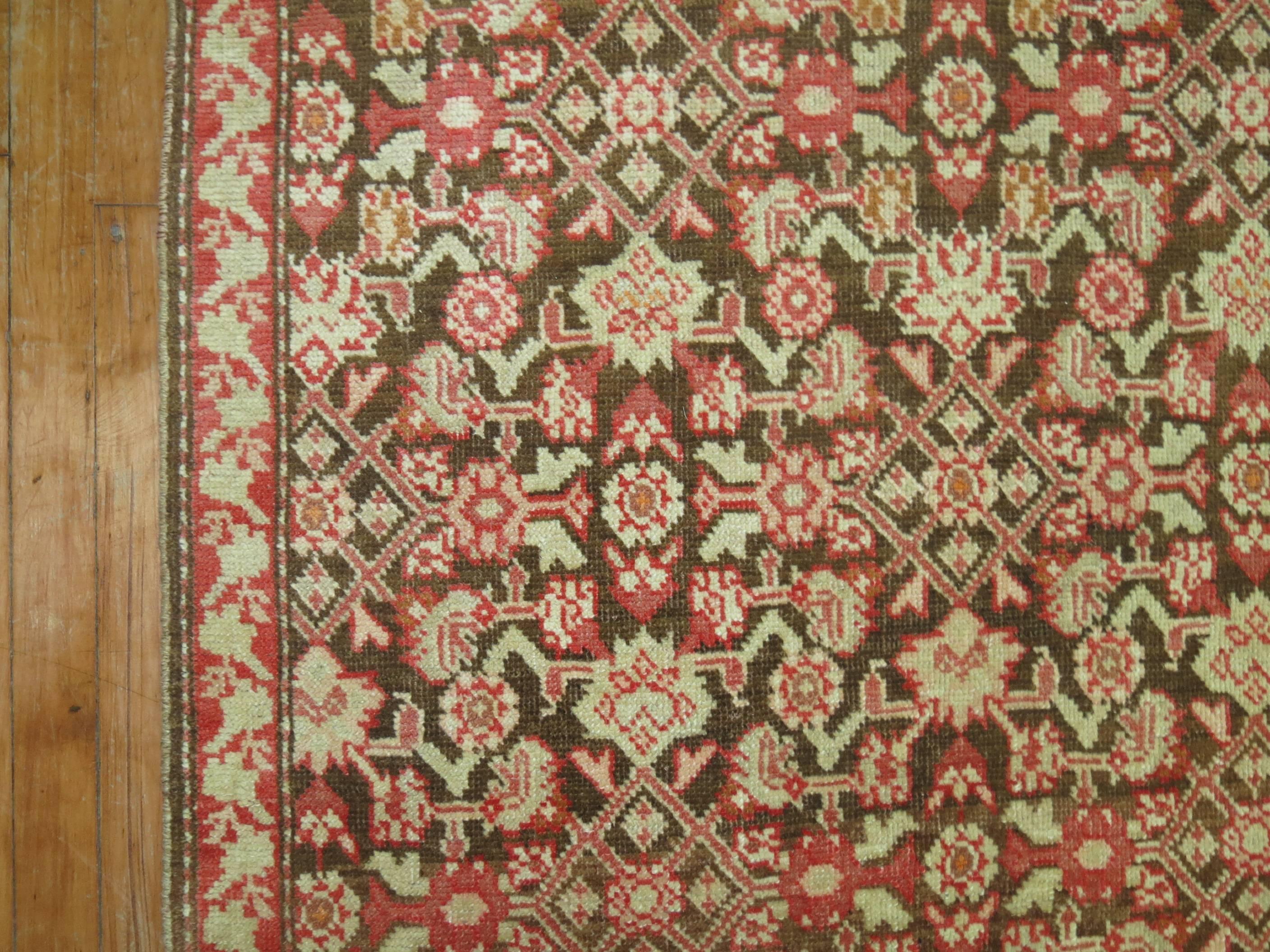 One of a kind narrow and wide Karabagh runner accents in brown and red, circa 1920.

Measures: 3'7'' x 16'2''.