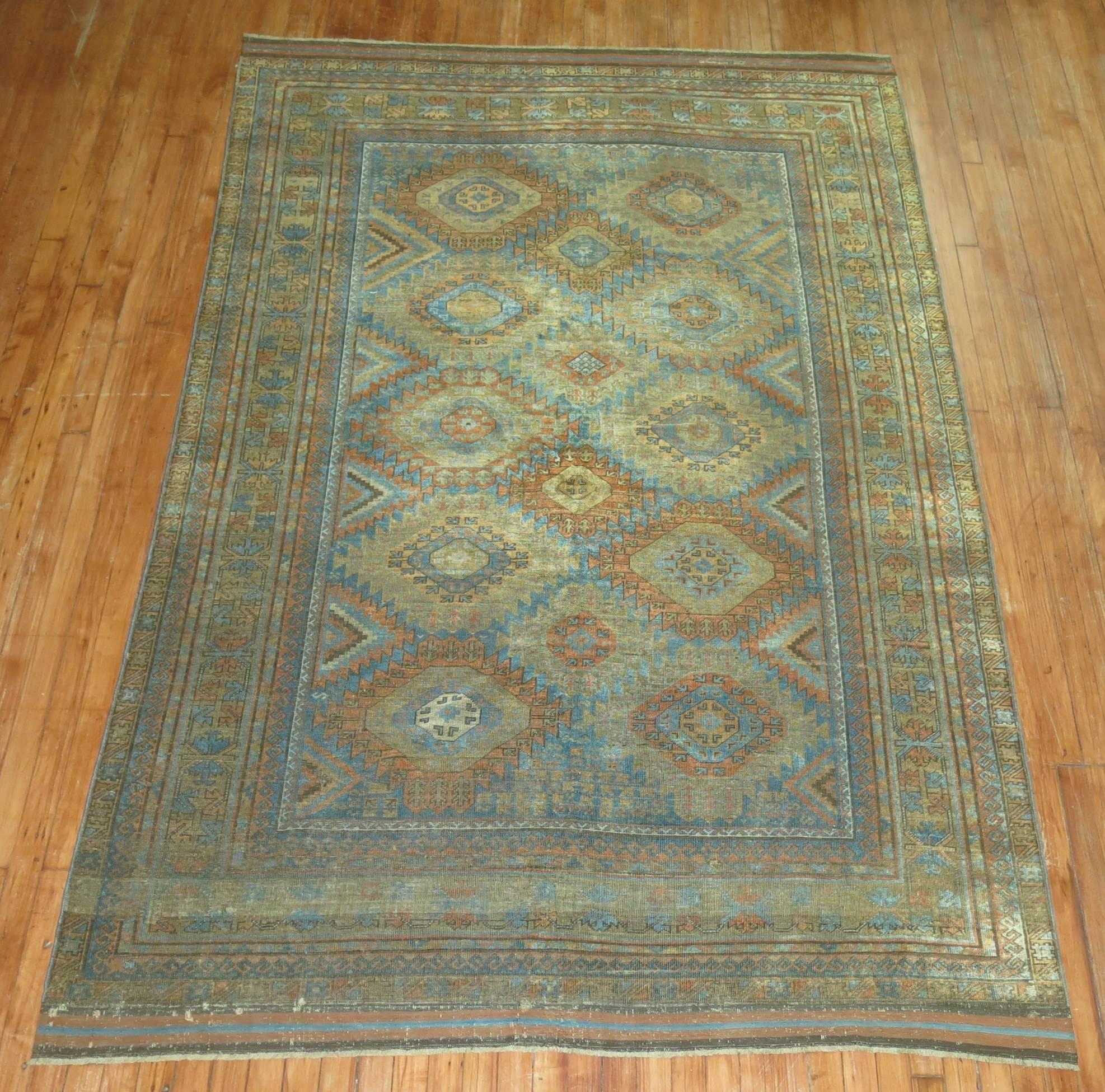 An early 20th century rustic color Afghan Balouch (Baluchi) carpet. All-over geometric design in browns, terracotta, and copper accents on a blue ground

Measures: 5'9
