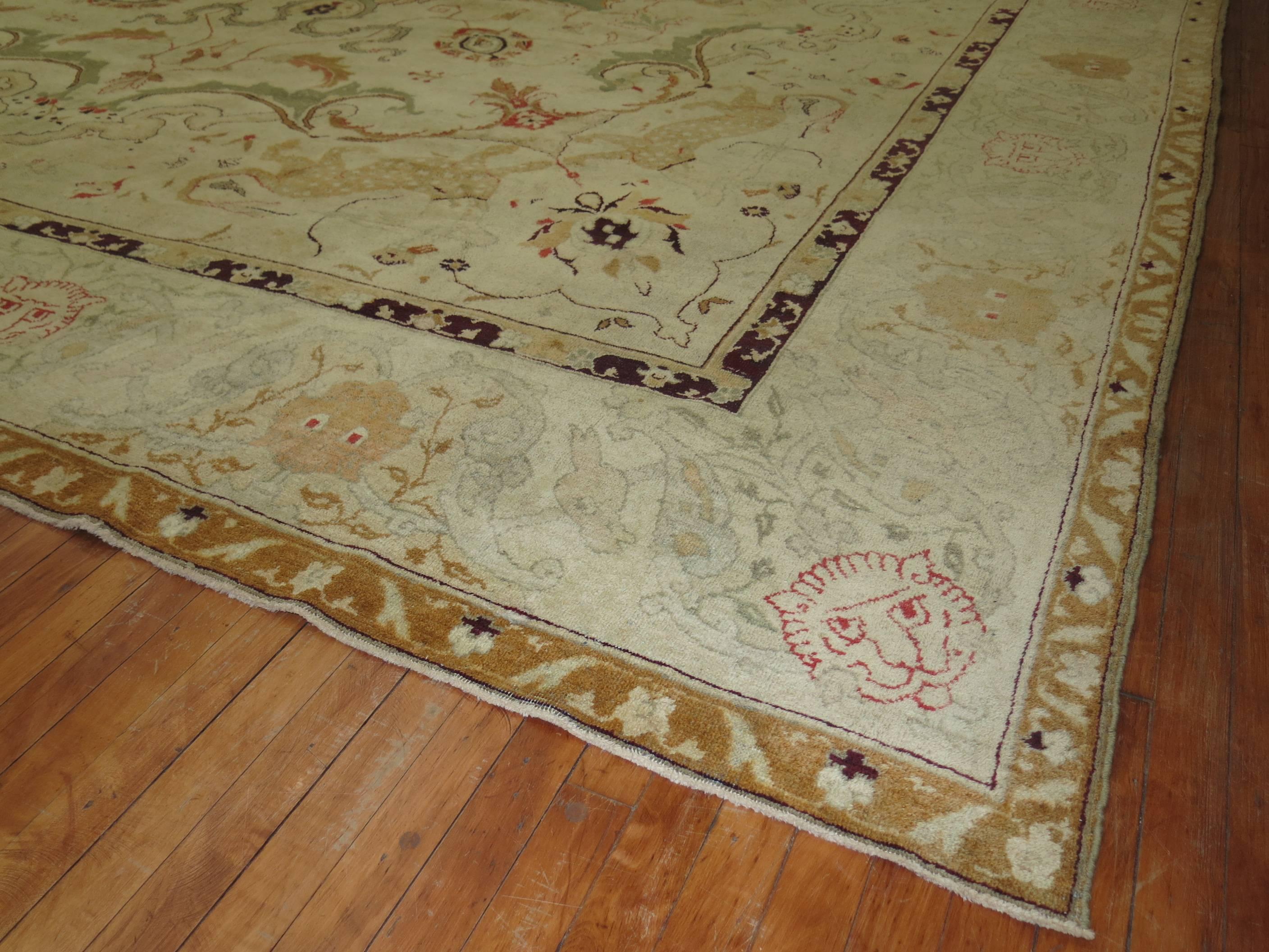 A stunning late 19th-early 20th century Antique Indian Agra carpet. Ivory field with predominant accents in gold, green and burgundy.

Agra carpets combine the grandeur and grace of well-known Persian court antique carpet designs with new motifs