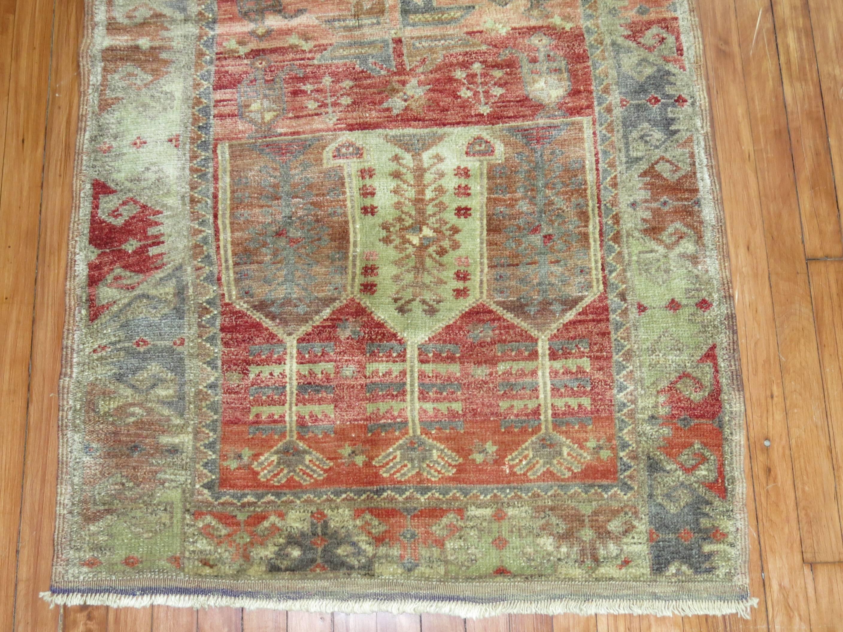 One of a kind midcentury Turkish Anatolian throw rug. Muted red field, predominant accents in celadon green, gray, blue.

Measures: 3'1” x 5'7”.