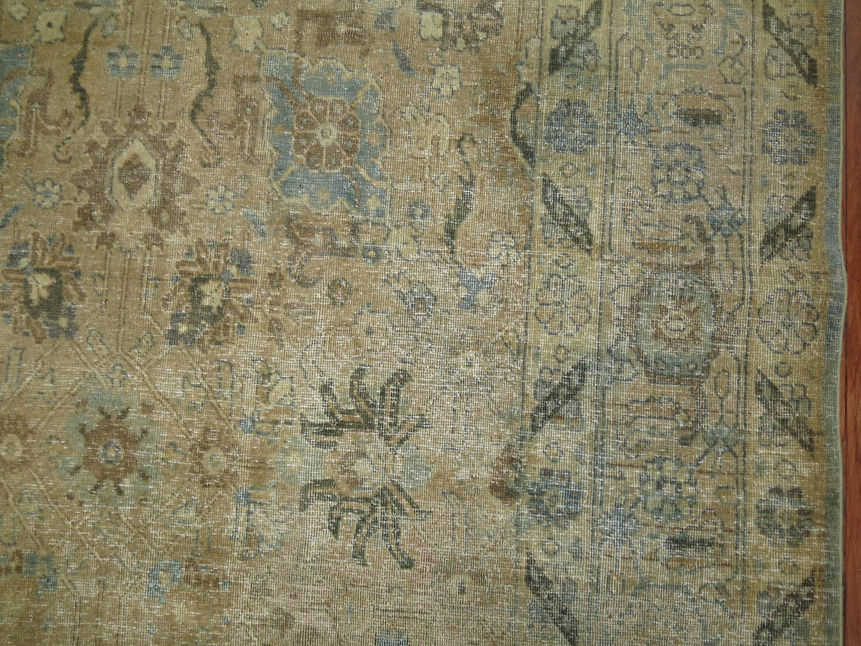 Antique Persian Tabriz rug in camel, brown, blue from the 1920s. Great wear and texture throughout the piece.

7'5'' x 10'8''