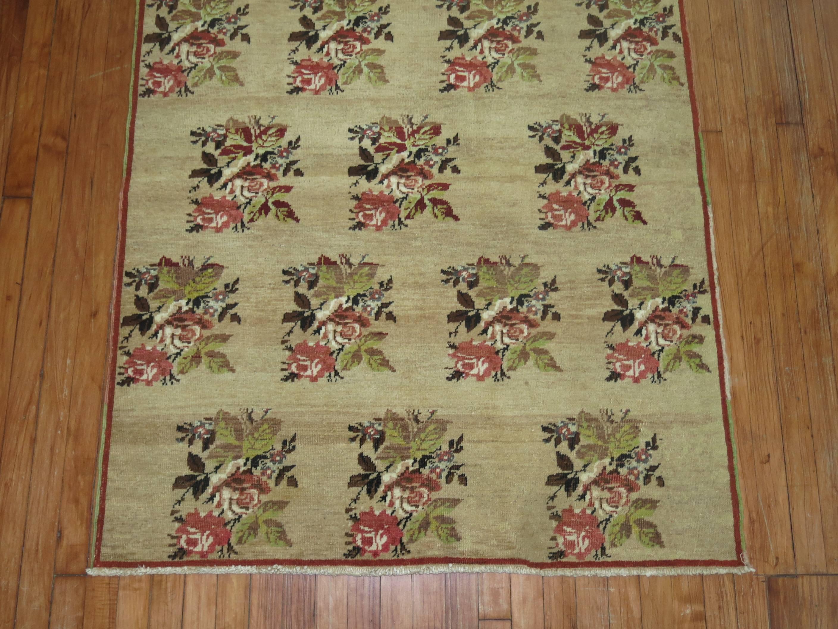 Vintage Turkish rug with an all-over floral design on a came colored ground.

3'10'' x 7'2''